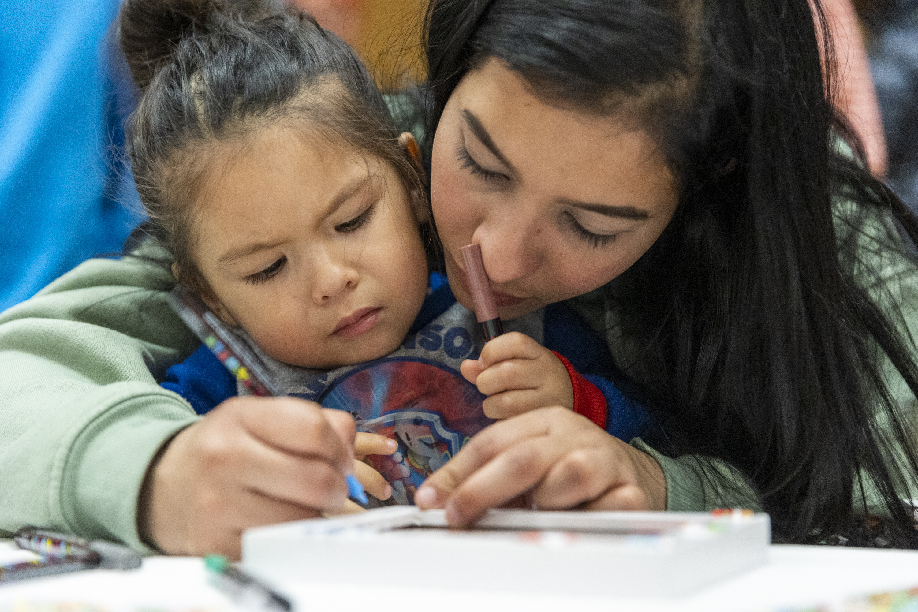 Diana Villegas helps Ian Luca decorate a picture frame at the Utah Refugee Connection "Celebration of Light" at Lincoln Elementary School in South Salt Lake on Saturday, Dec. 17. It was only a few years ago, in some cases only a few months, that they had never heard "White Christmas," let alone knew what one looked like … and many had no idea who Santa Claus was, either.
