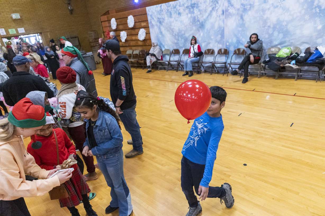 Zamir Amiri, 10, bounces a ballon at the Utah Refugee Connection "Celebration of Light" at Lincoln Elementary School in South Salt Lake on Saturday, Dec. 17. It was only a few years ago, in some cases only a few months, that they had never heard "White Christmas," let alone knew what one looked like … and many had no idea who Santa Claus was, either.