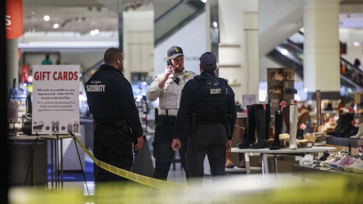 Security officers speak inside a store at the Mall of America in Bloomington, Minn., after reports of shots fired on Friday. On Saturday, police announced that five people were arrested in connection with the shooting.