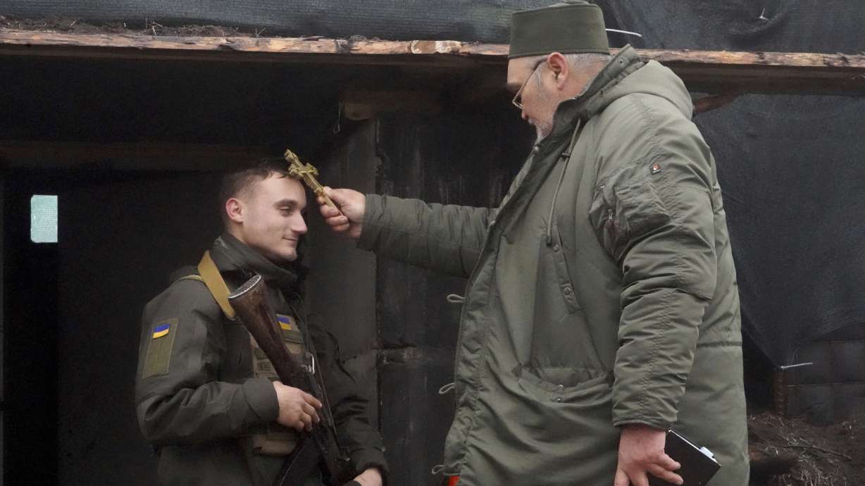 A chaplain blesses a soldier to mark Christmas at Ukraine's National Guard position close to the Russian border near Kharkiv, Ukraine, Saturday.