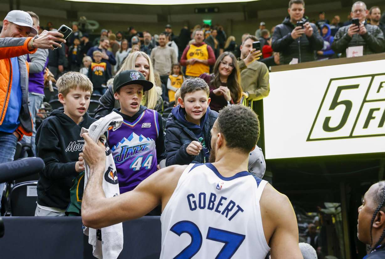 Utah Jazz fans get autographs from Minnesota Timberwolves' Rudy Gobert (27) after a game in Salt Lake City on Dec. 9. The Jazz traded Gobert to the Timberwolves in July.