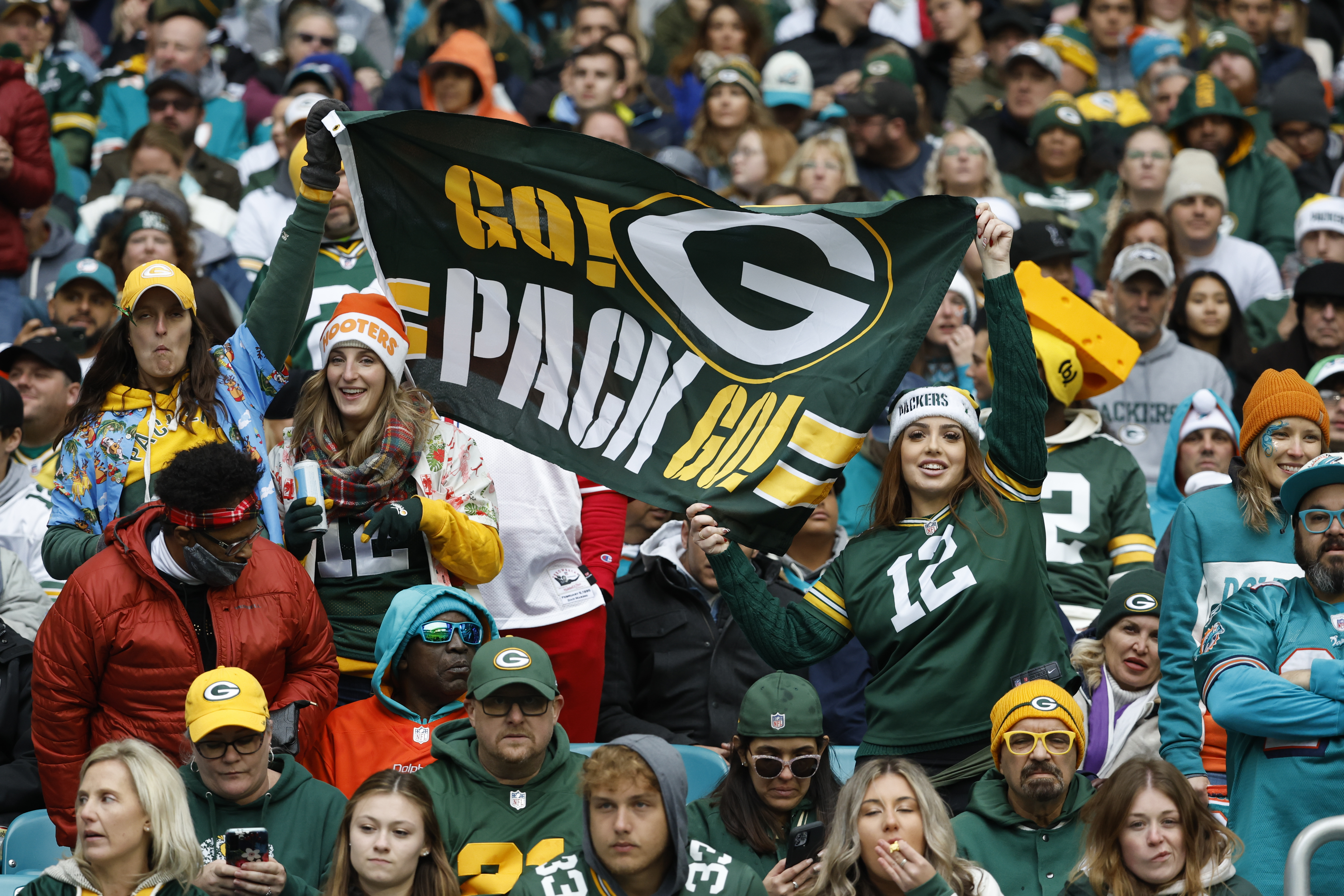 Green Bay Packers fans cheer on their team during the first half of an NFL football game against the Miami Dolphins, Sunday, Dec. 25, 2022, in Miami Gardens, Fla.
