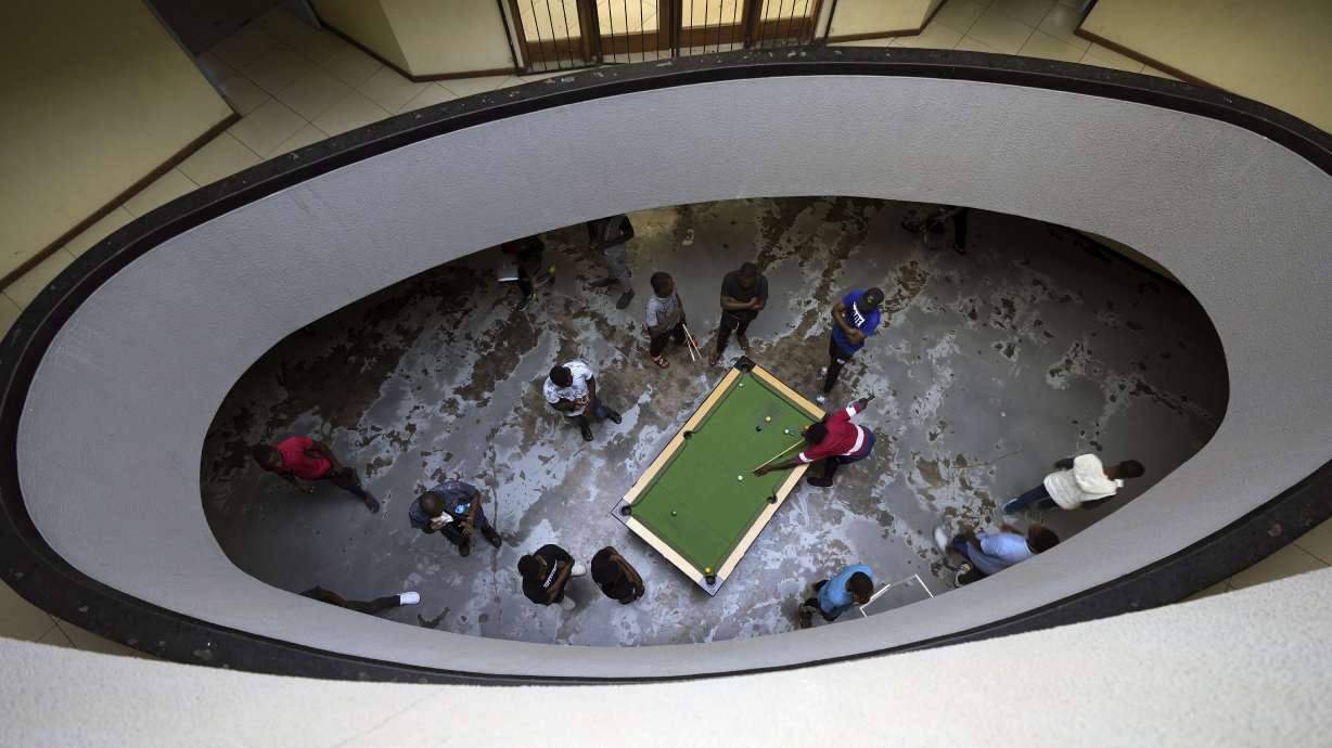 People play pool in Harare, Zimbabwe, Thursday, Nov. 24, 2022. Previously a minority and elite sport in Zimbabwe, the game has increased in popularity over the years, first as a pastime and now as a survival mode for many in a country where employment is hard to come by.