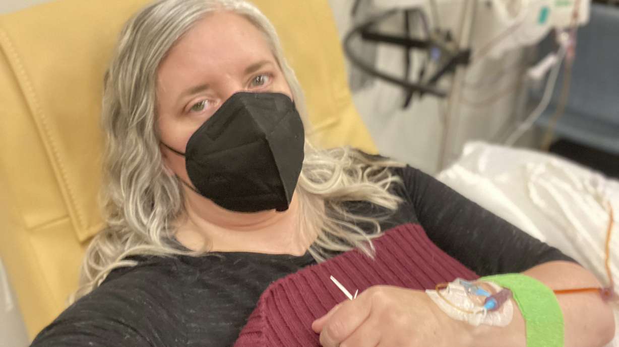 Amy Watson, of Portland, Ore., during an iron infusion in December 2022. Watson, approaching 50, says she has “never had any kind of recovery” from COVID-19. She has had severe migraines, plus digestive, nerve and foot problems. Recently she developed severe anemia.