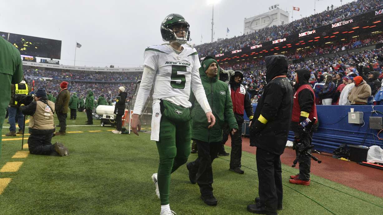 New York Jets quarterback Mike White (5) walks to the locker room during the second half of an NFL football game against the Buffalo Bills, Sunday, Dec. 11, 2022, in Orchard Park, N.Y. As a precaution, Jets head coach Robert Saleh said White was sent to the hospital after the game to be evaluated.