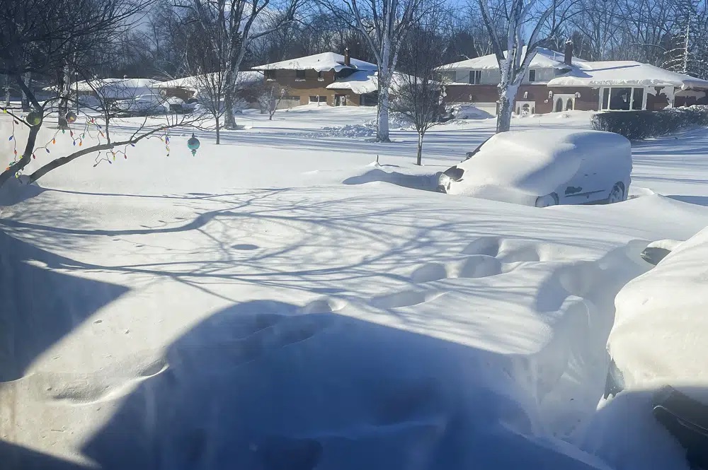 A car sits blanketed in snow on a driveway, Sunday in Amherst, N.Y. Millions of people hunkered down against a deep freeze Sunday morning to ride out the frigid storm that has killed at least 24 people across the United States and is expected to claim more lives after trapping some residents inside houses with heaping snow drifts and knocking out power to several hundred thousand homes and businesses.