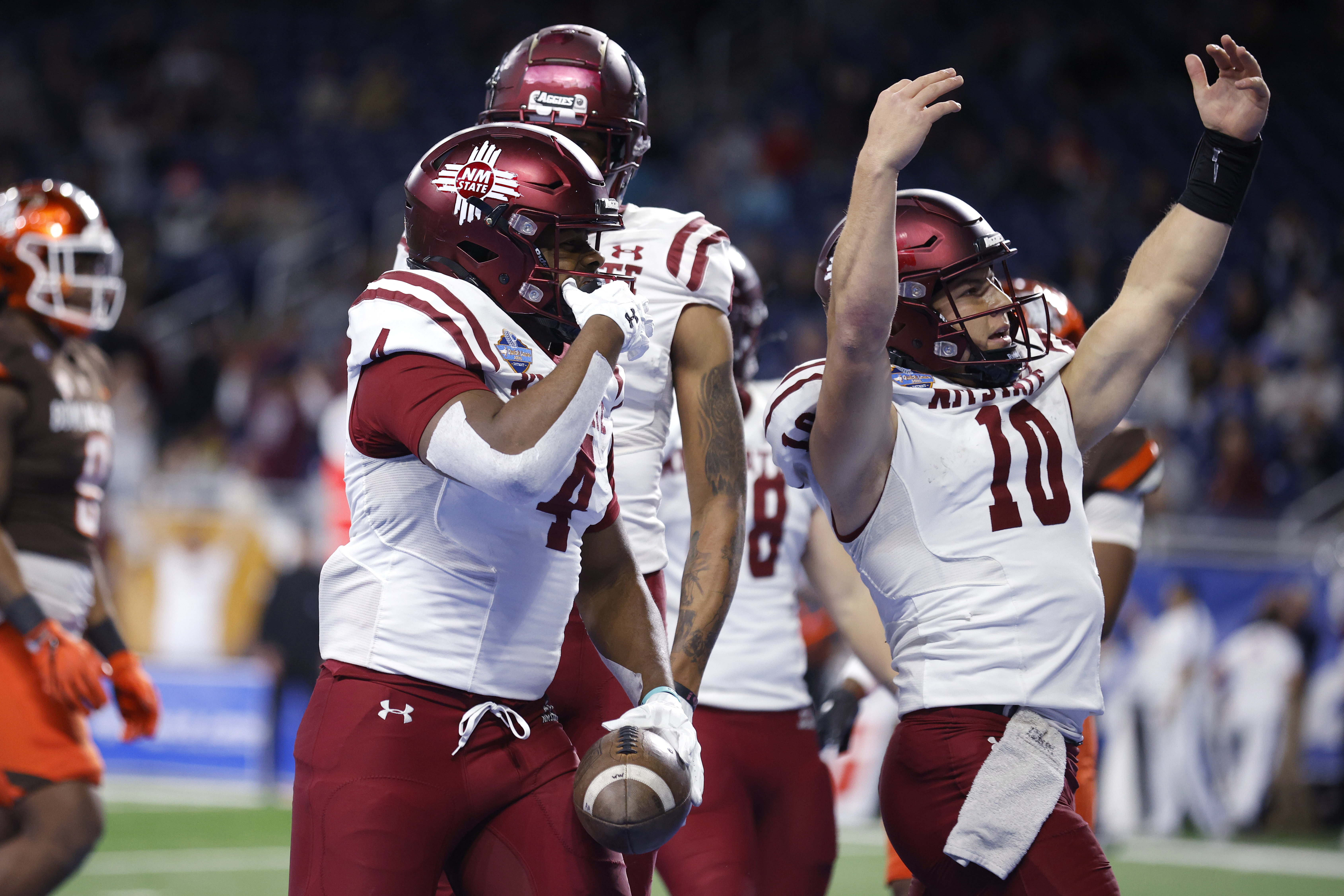 New Mexico State running back Star Thomas, left, and quarterback Diego Pavia (10) celebrate after Thomas' pass reception touchdown against Bowling Green during the first half of the Quick Lane Bowl NCAA college football game, Monday, Dec. 26, 2022, in Detroit. 