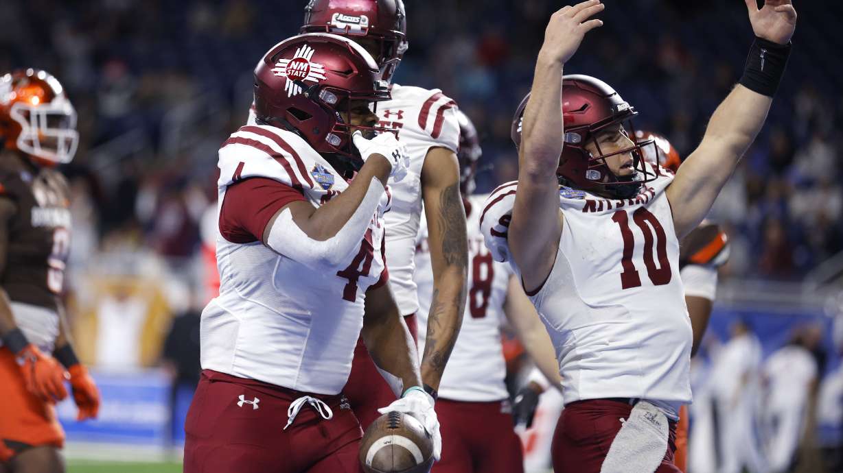 New Mexico State running back Star Thomas, left, and quarterback Diego Pavia (10) celebrate after Thomas' pass reception touchdown against Bowling Green during the first half of the Quick Lane Bowl NCAA college football game, Monday, Dec. 26, 2022, in Detroit.