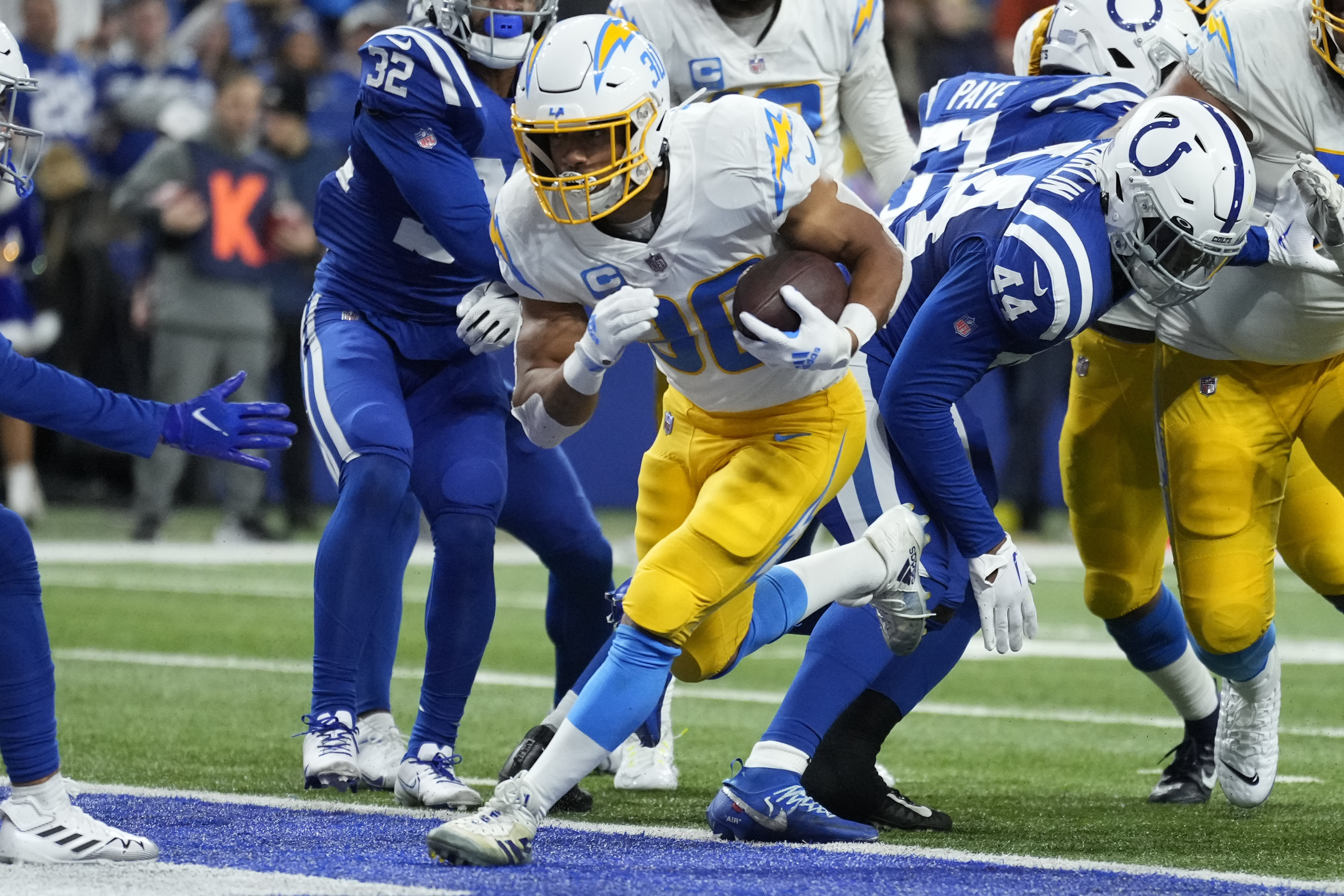 Los Angeles Chargers' Austin Ekeler (30) runs in for a touchdown during the first half of an NFL football game against the Indianapolis Colts, Monday, Dec. 26, 2022, in Indianapolis. 