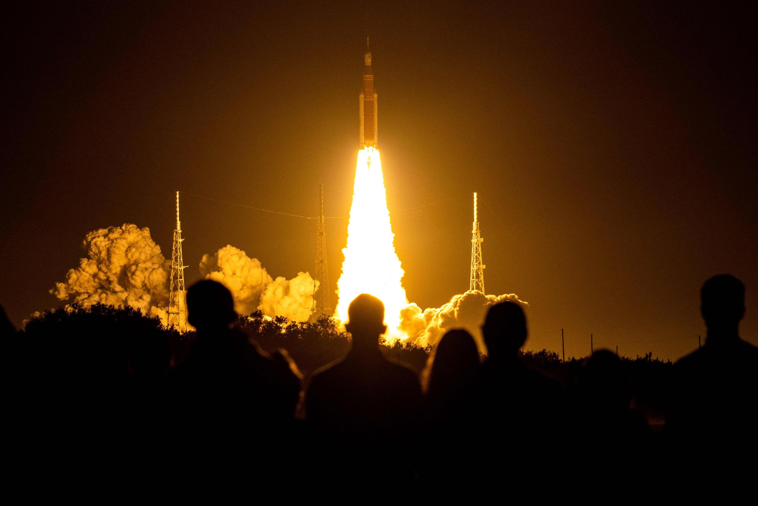 Spectators watch as the Artemis I uncrewed lunar rocket lifts off at NASA's Kennedy Space Center in Cape Canaveral, Florida, on Nov. 16, 2022.