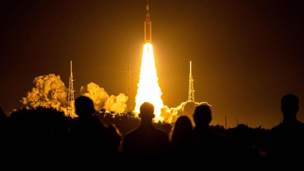 Spectators watch as the Artemis I uncrewed lunar rocket lifts off at NASA's Kennedy Space Center in Cape Canaveral, Florida, on Nov. 16, 2022.
