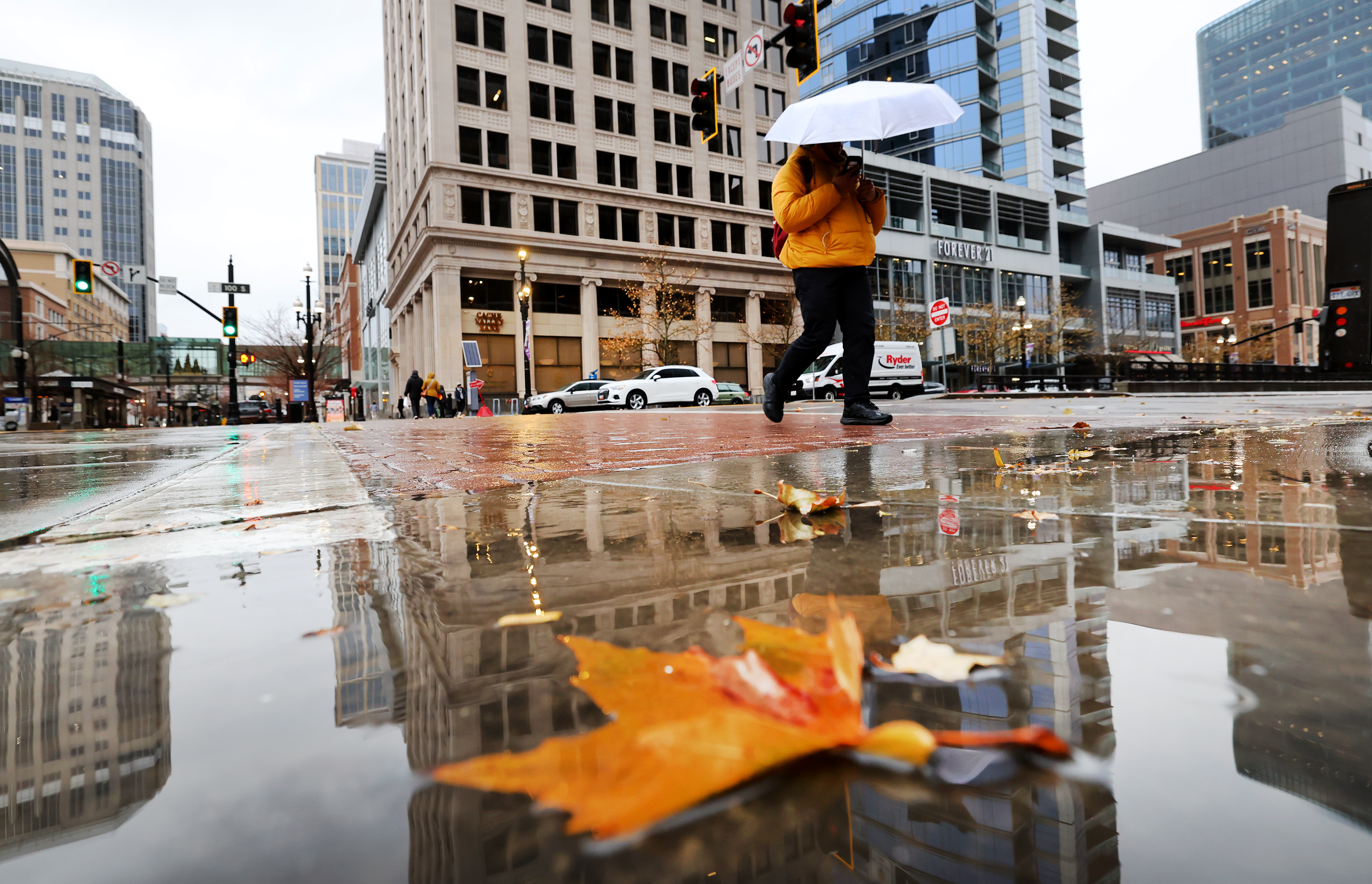 A pedestrian uses an umbrella to shield themselves from the rain in Salt Lake City on Tuesday.