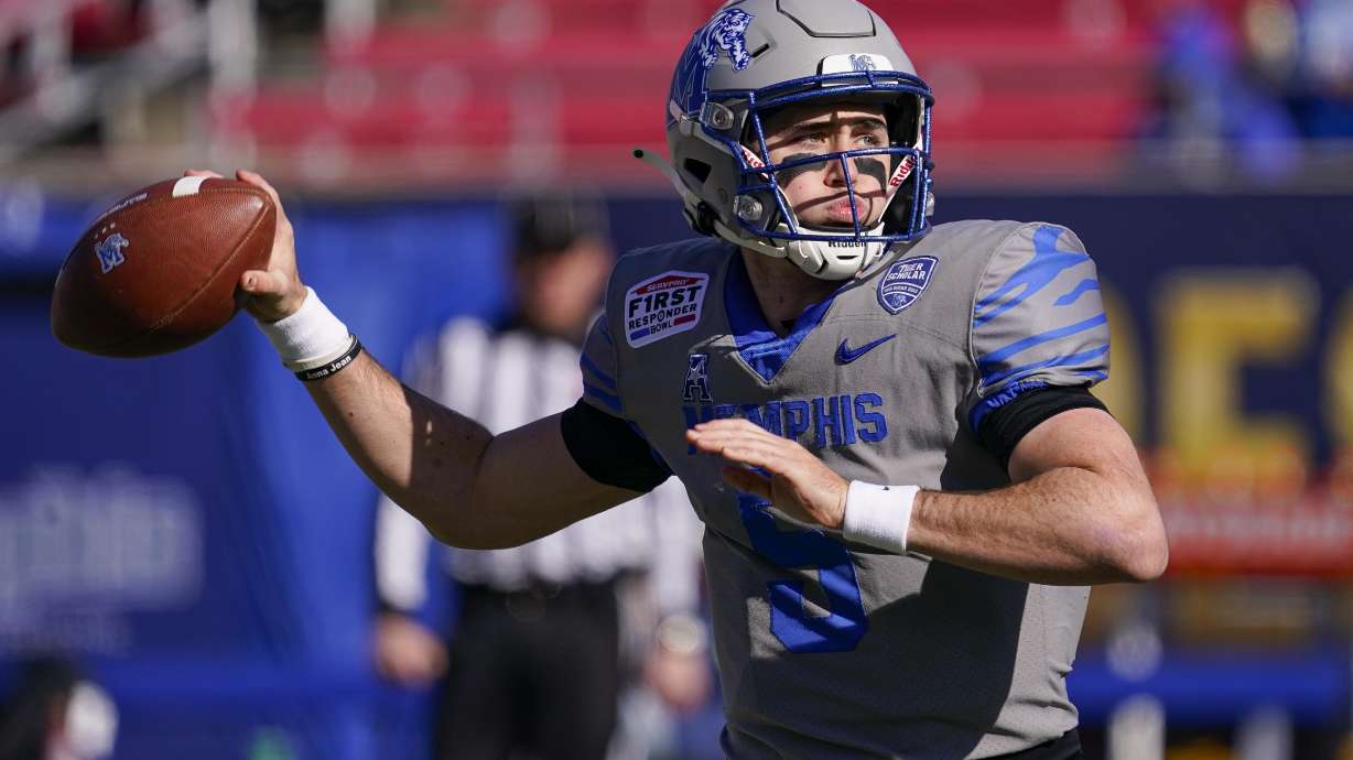 Memphis quarterback Seth Henigan (5) warms up before the First Responder Bowl NCAA college football game against Utah State Tuesday, Dec. 27, 2022, in Dallas.