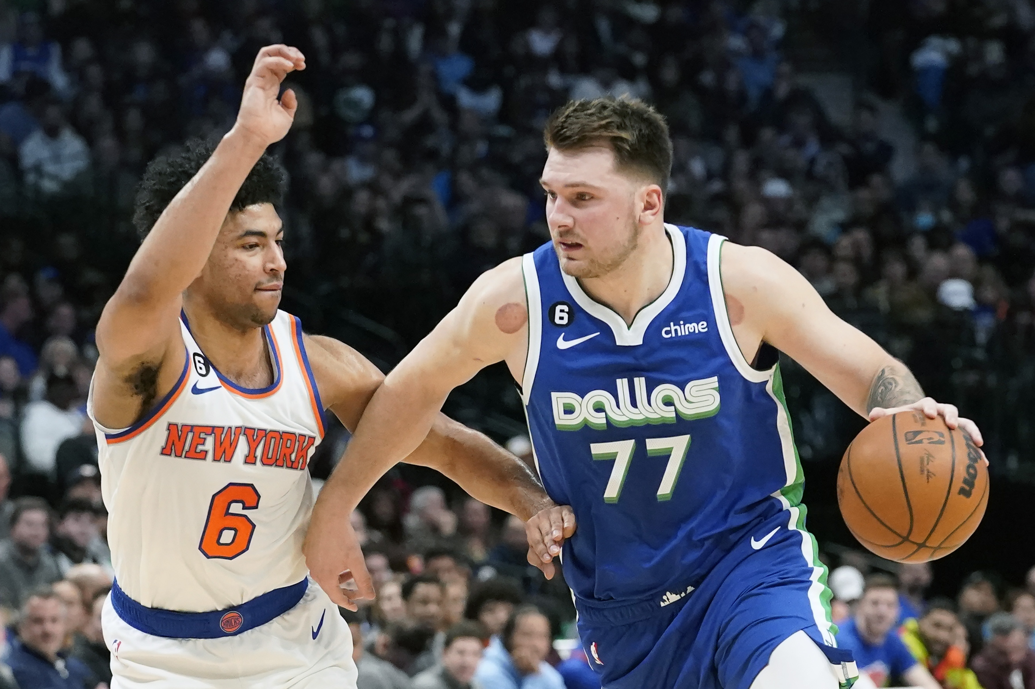 Dallas Mavericks guard Luka Doncic (77) drives against New York Knicks guard Quentin Grimes (6) during the first quarter of an NBA basketball game in Dallas, Tuesday, Dec. 27, 2022. 