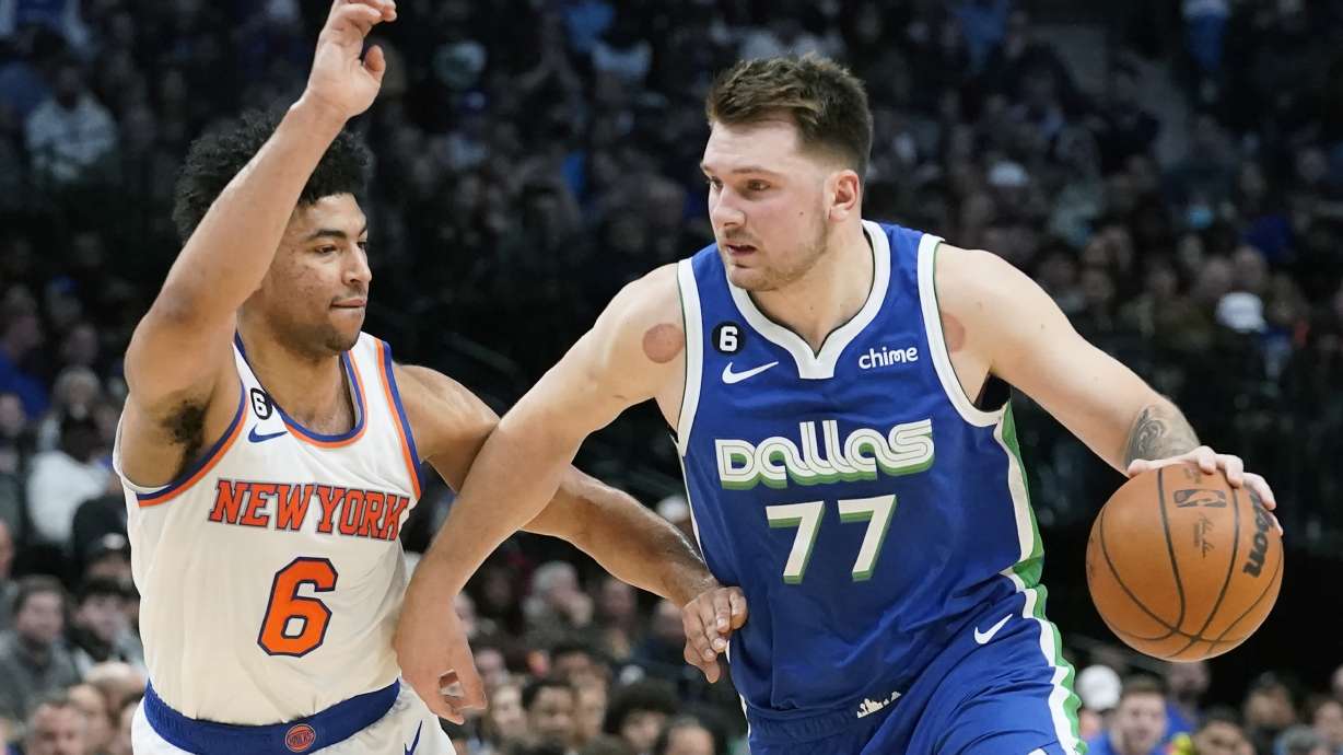 Dallas Mavericks guard Luka Doncic (77) drives against New York Knicks guard Quentin Grimes (6) during the first quarter of an NBA basketball game in Dallas, Tuesday, Dec. 27, 2022.