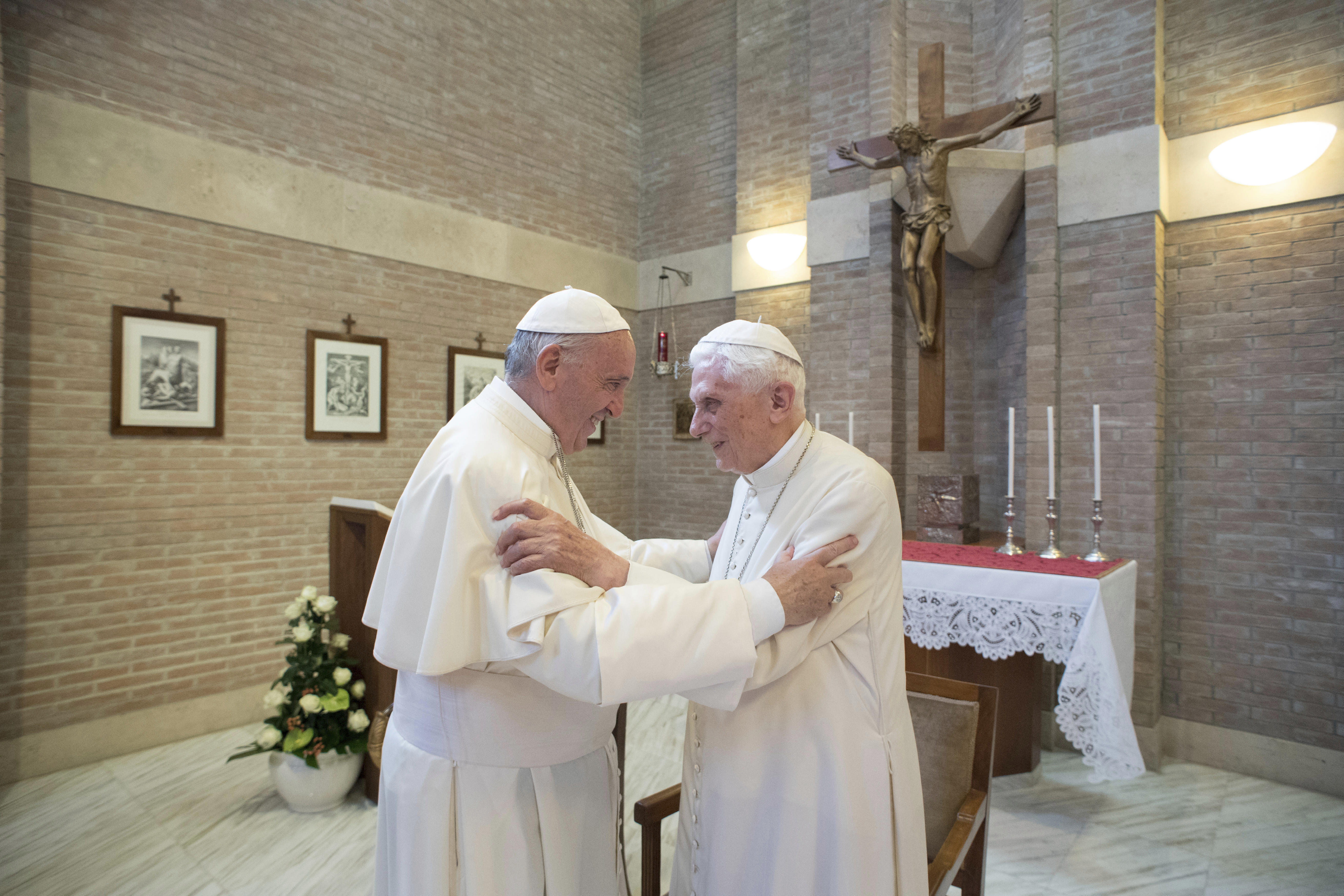 Pope Francis, left, embraces Emeritus Pope Benedict XVI, at the Vatican, June 28, 2017.