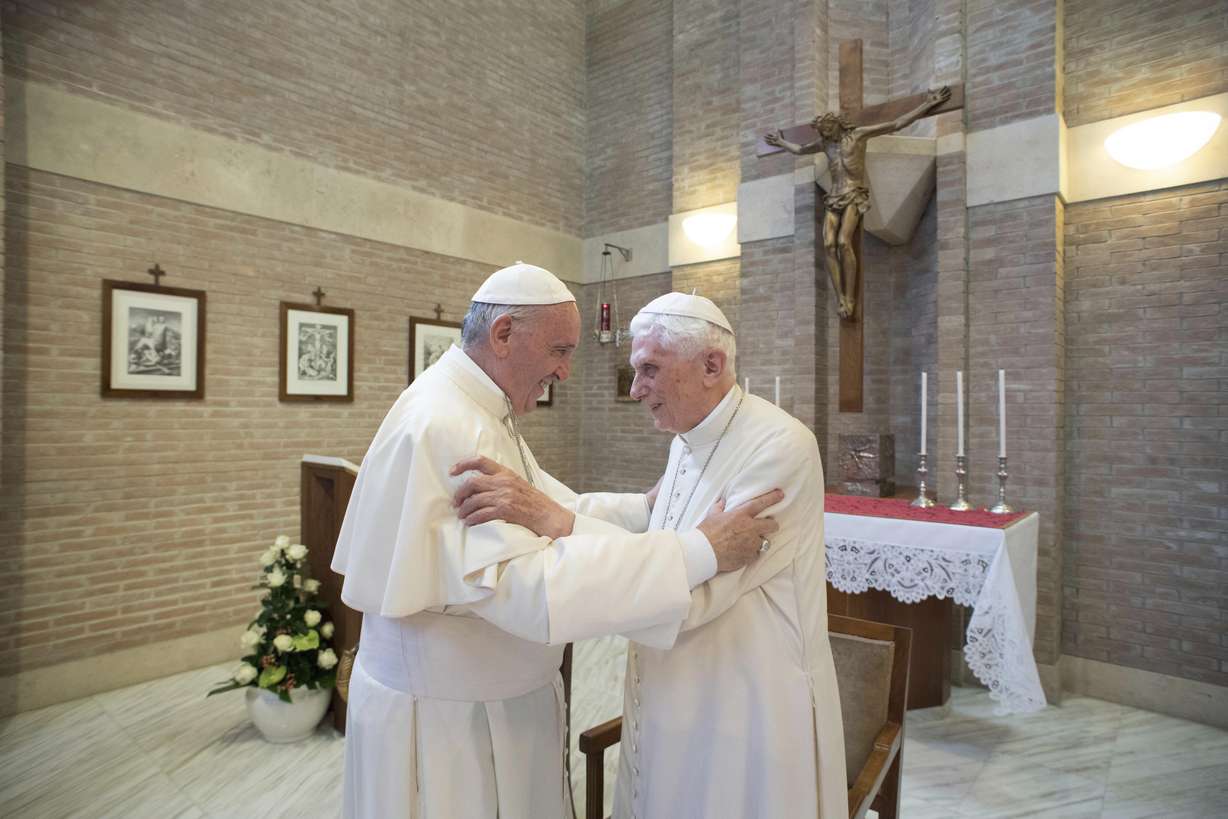 Pope Francis, left, embraces Emeritus Pope Benedict XVI, at the Vatican, June 28, 2017.