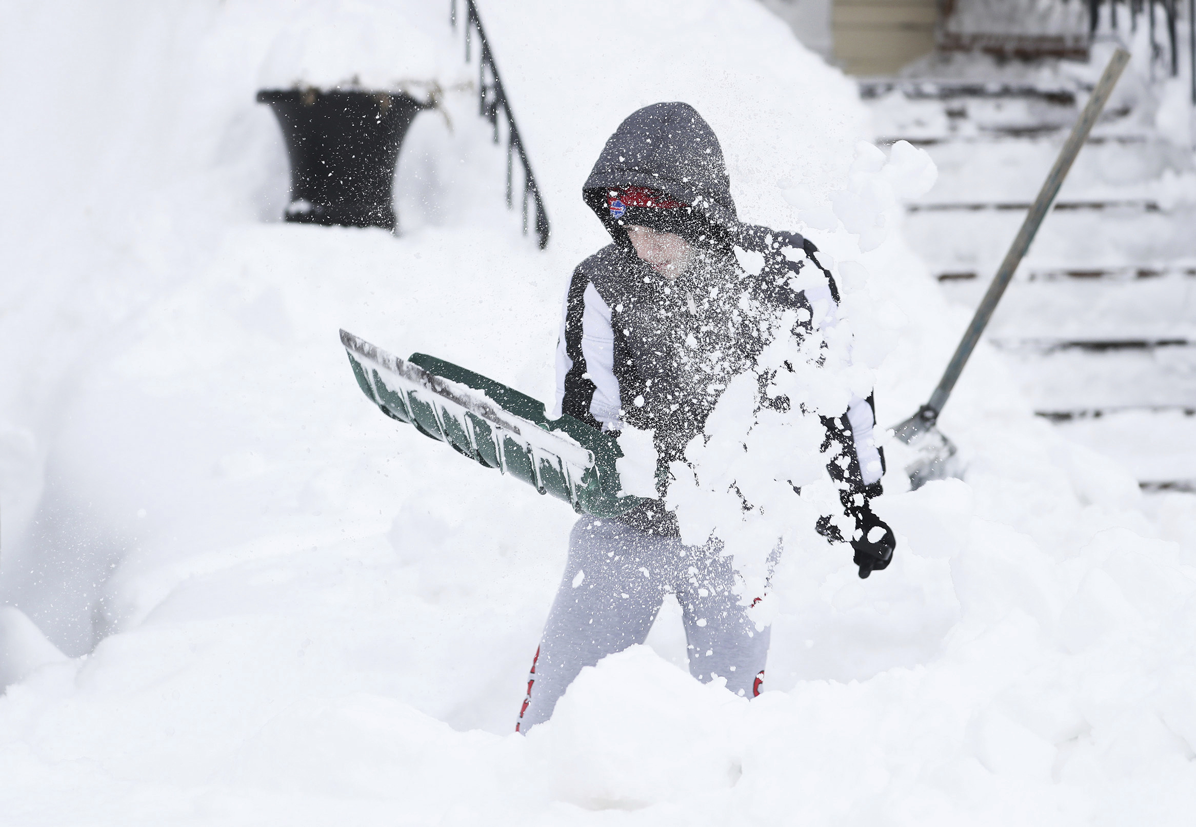 Angelo Milioto, 13, shovels snow away from around his home in Buffalo, N.Y., on Tuesday. Clean up is currently under way after a blizzard hit four Western New York counties.