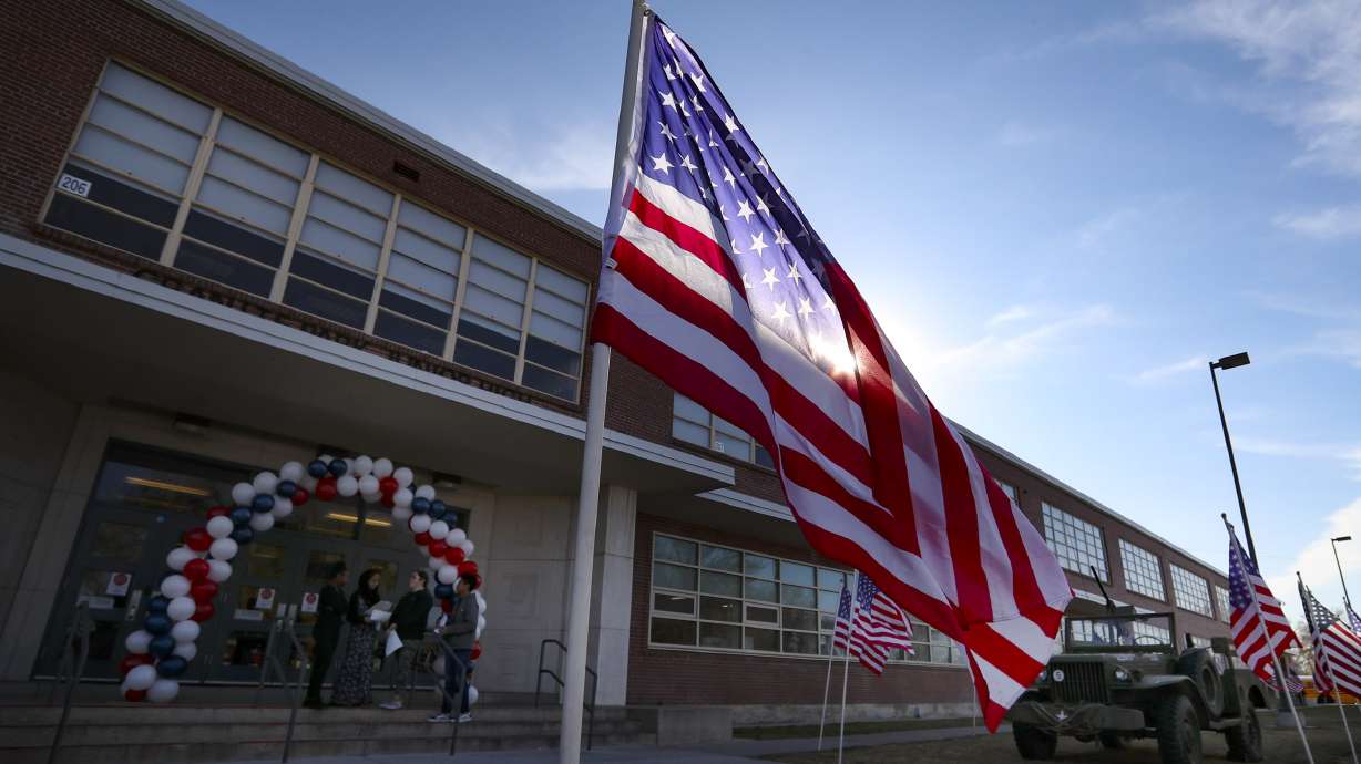 American flags wave at Granite Park Junior High School in South Salt Lake on Nov. 11, 2019. A staff member at the school was charged Wednesday with engaging in sexual activity with a 14-year-old student.