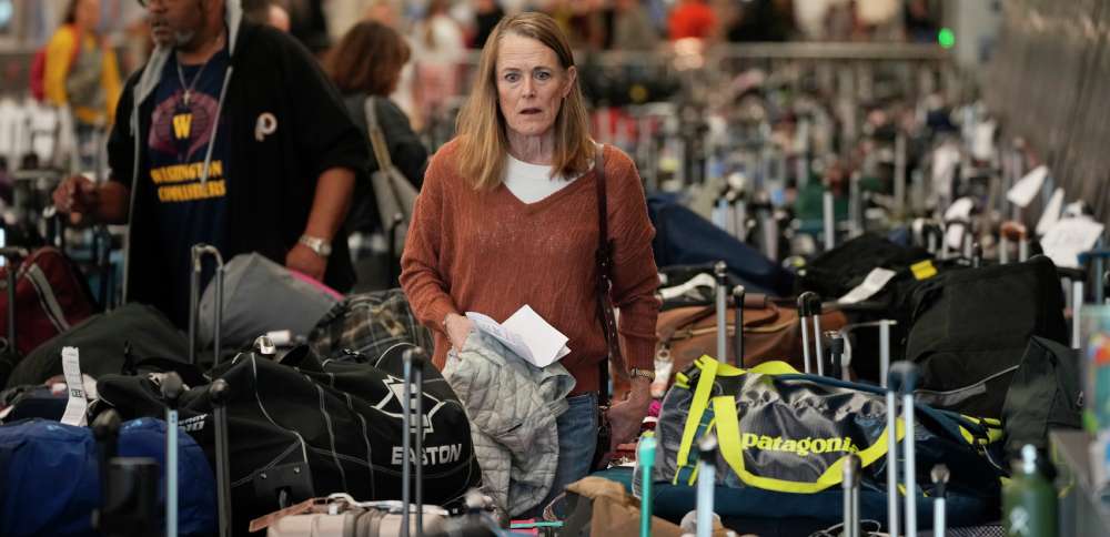 A traveler wades through the field of unclaimed bags at the Southwest Airlines luggage carousels at Denver International Airport on Tuesday.