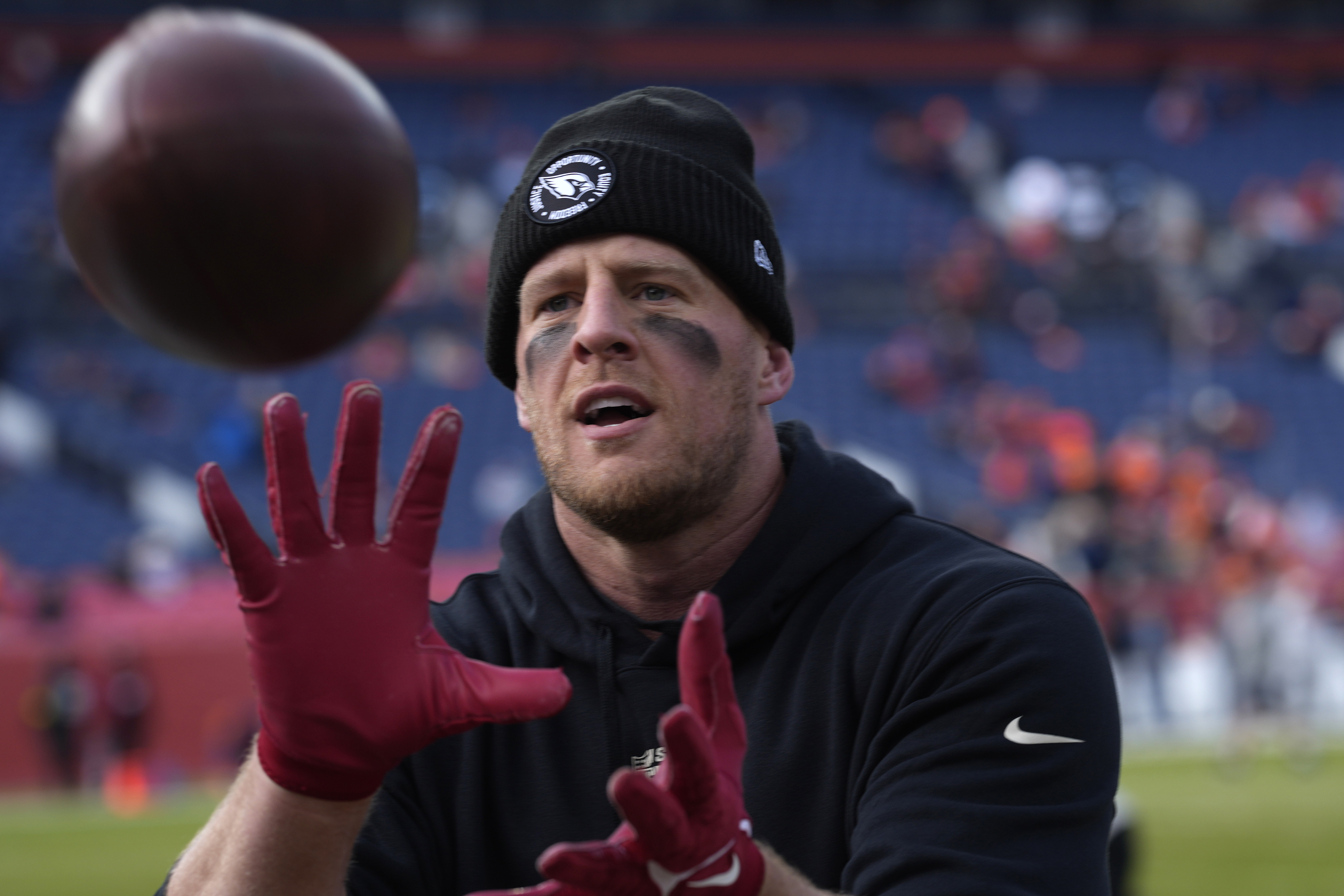 Arizona Cardinals defensive end J.J. Watt plays catch with fans prior to an NFL football game against the Denver Broncos, Sunday, Dec. 18, 2022, in Denver. 