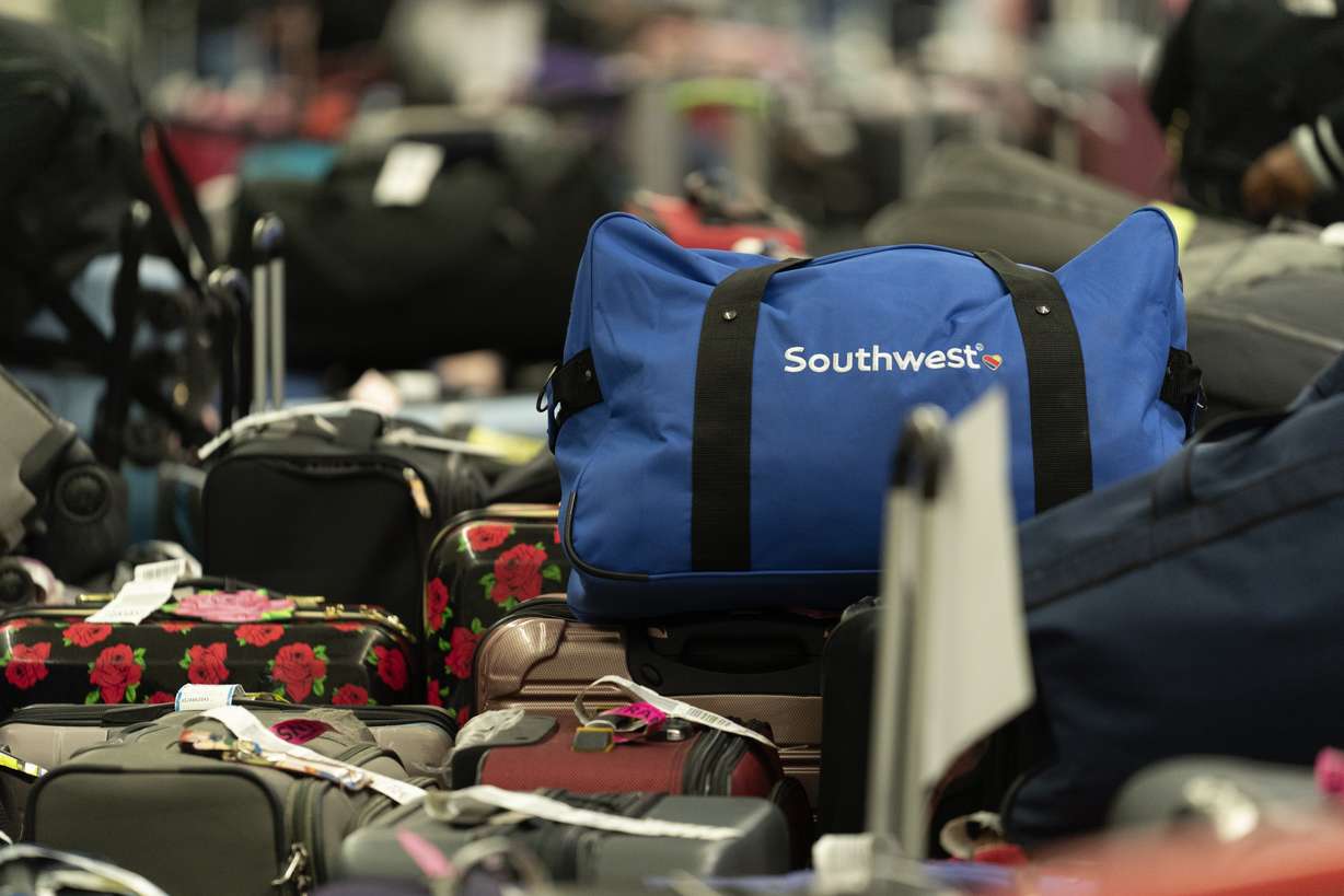 Hundreds of Southwest Airlines checked bags are piled at baggage claim at Midway International Airport as Southwest continues to cancel thousands of flights across the country Wednesday, in Chicago.