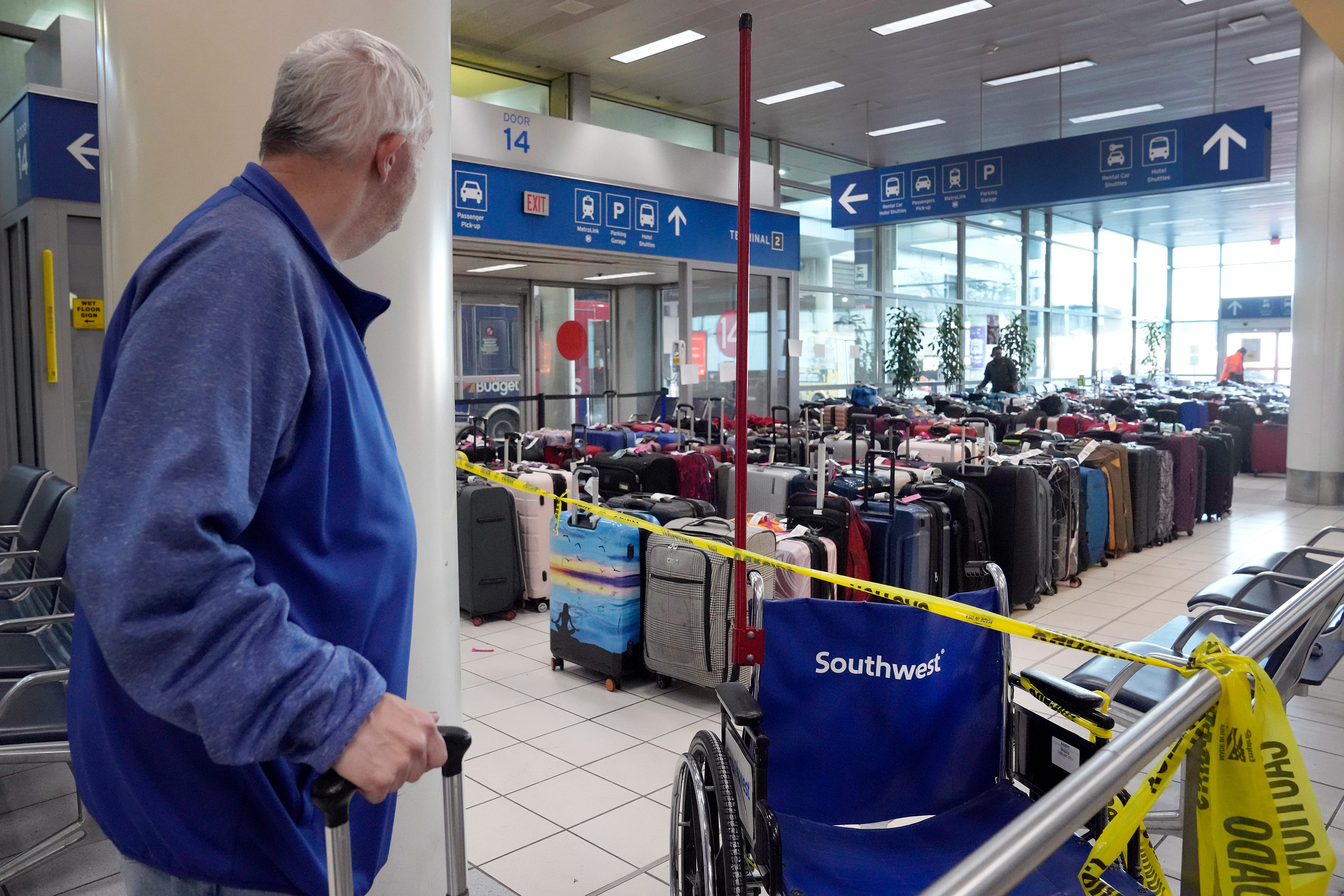 A traveler looks at luggage in the baggage claim area inside the Southwest Airlines terminal at St. Louis Lambert International Airport on Wednesday.