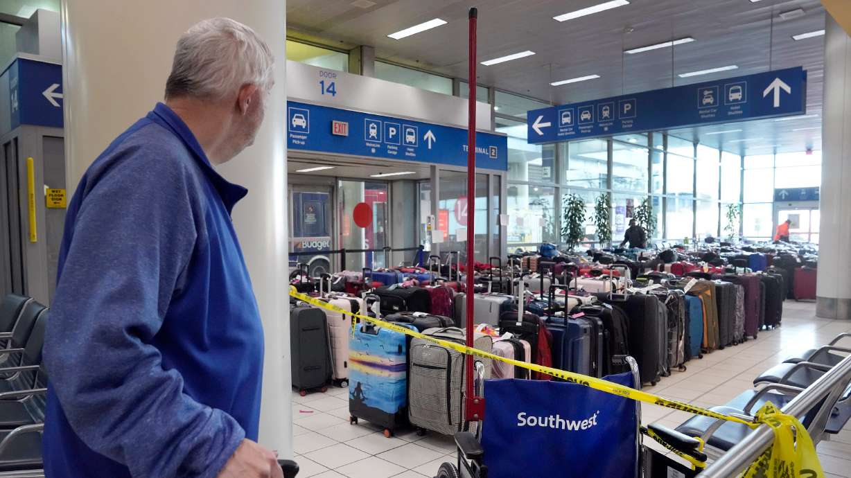A traveler looks at luggage in the baggage claim area inside the Southwest Airlines terminal at St. Louis Lambert International Airport on Wednesday.