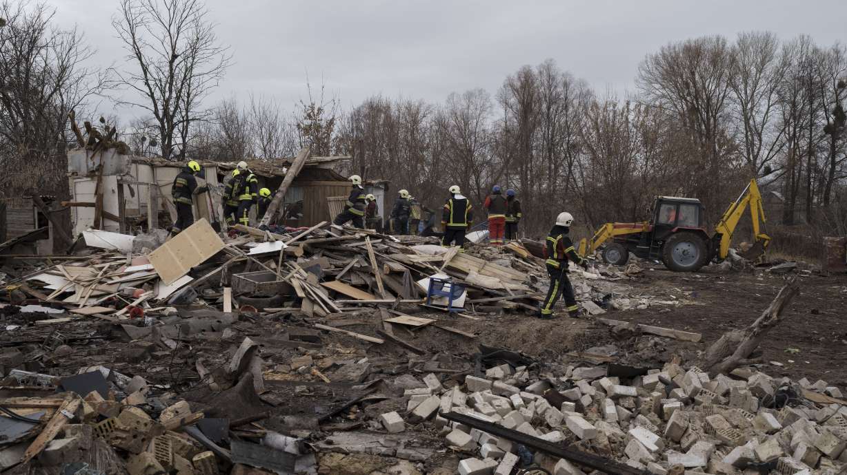 Emergency workers remove debris of a house destroyed following a Russian missile strike in Kyiv, Ukraine, Thursday. Multiple regions of the country have come under another massive Russian missile attack.