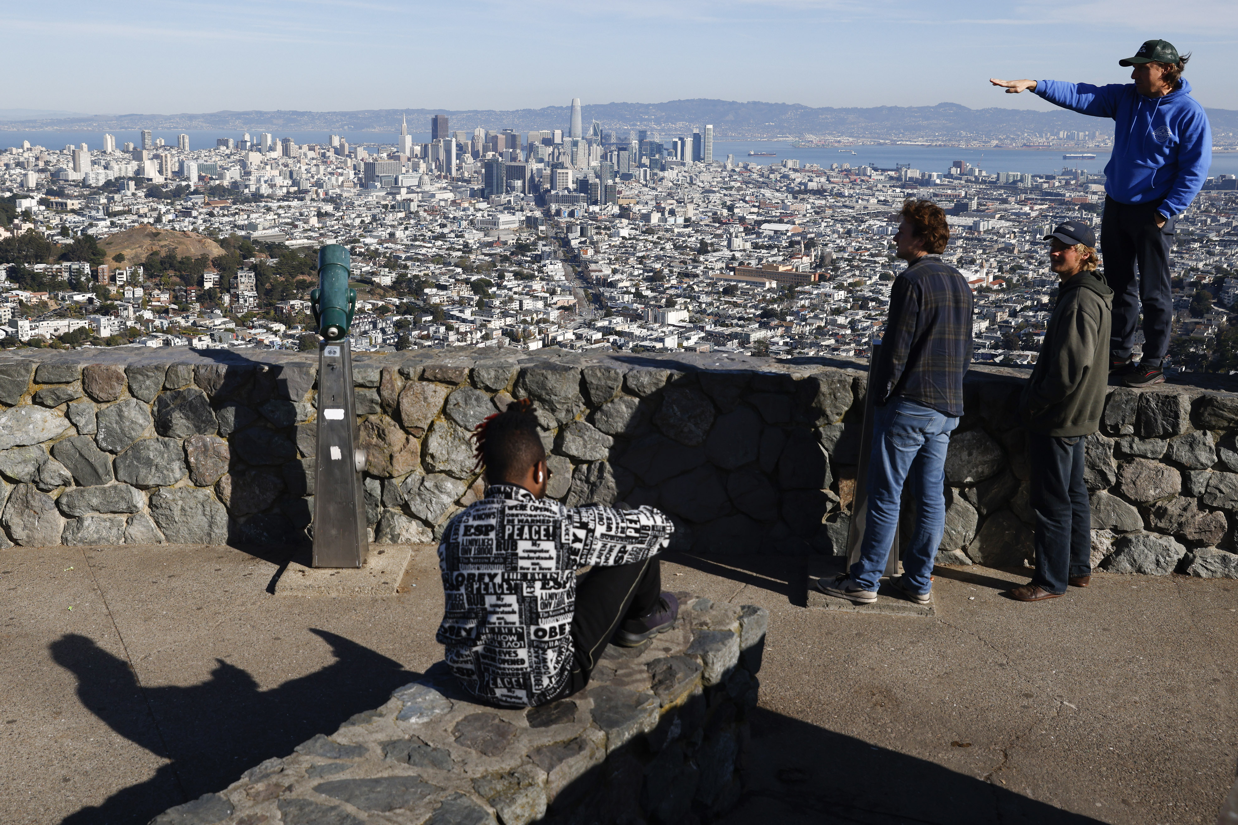 Tourists look out onto the city skyline from Christmas Tree Point on top of Twin Peaks in San Francisco Dec. 15. More than 1,100 towns, hamlets and villages in the U.S. lost their status as urban areas as the U.S. Census Bureau released a new list of places considered urban based on revised criteria.