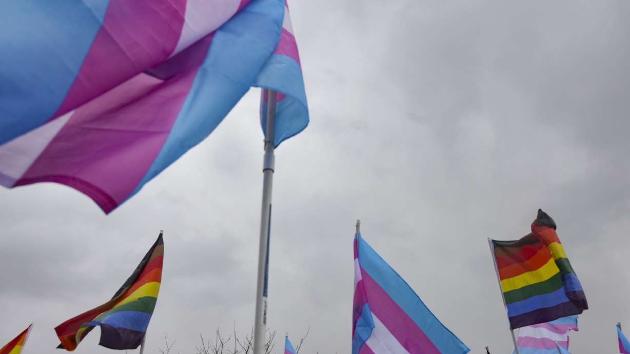 East High School students hold transgender and Pride flags during a protest against the passage of HB11 at the school in Salt Lake City on April 15. A newly proposed bill would prohibit gender-confirmation surgeries from being performed on minors.