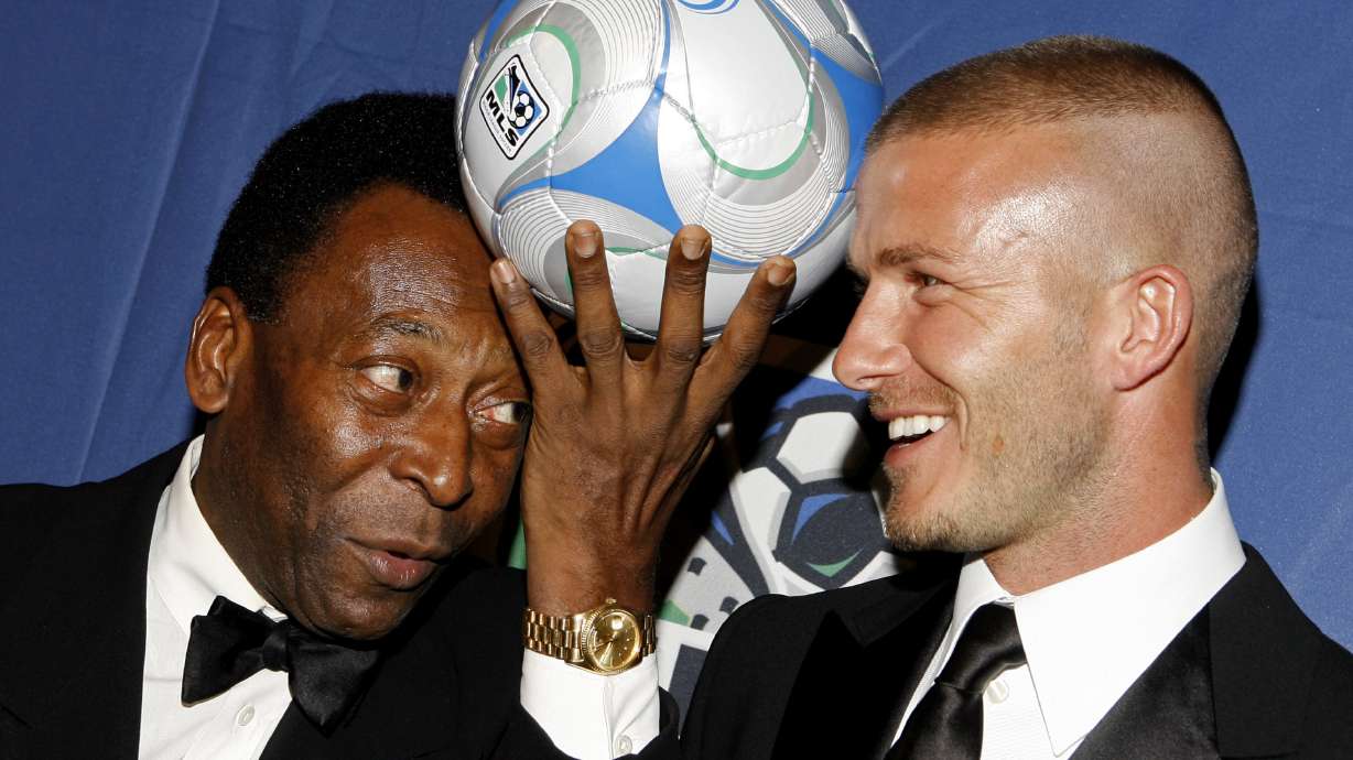 FILE - Brazilian soccer great Pele, and English soccer star David Beckham pose for photos during a U.S. Soccer Foundation fundraising gala, in New York, March 19, 2008. Pelé, the Brazilian king of soccer who won a record three World Cups and became one of the most commanding sports figures of the last century, died in Sao Paulo on Thursday, Dec. 29, 2022. He was 82.