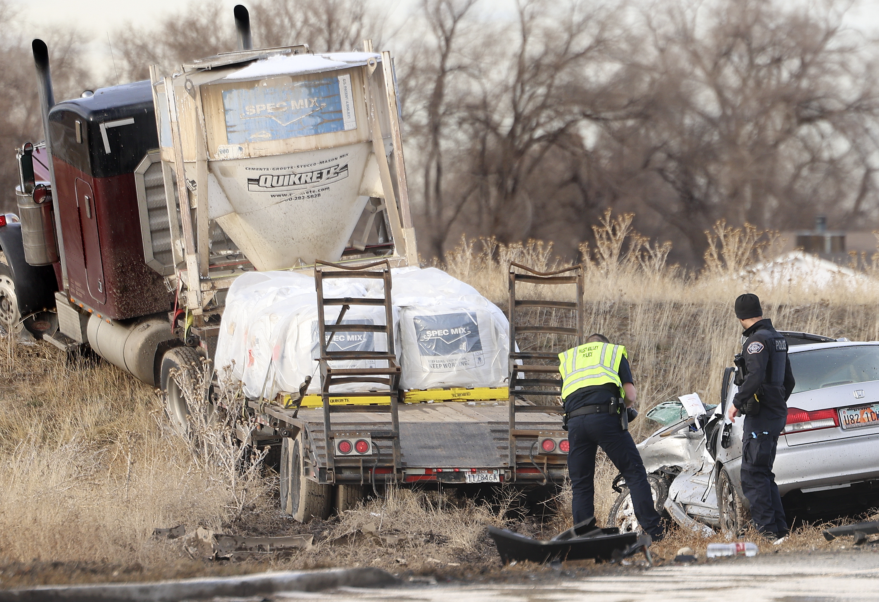 Law enforcement officials investigate a crash at 4100 South and Mountain View Corridor in West Valley City on Thursday. The crash involved three vehicles and one person was pronounced dead.