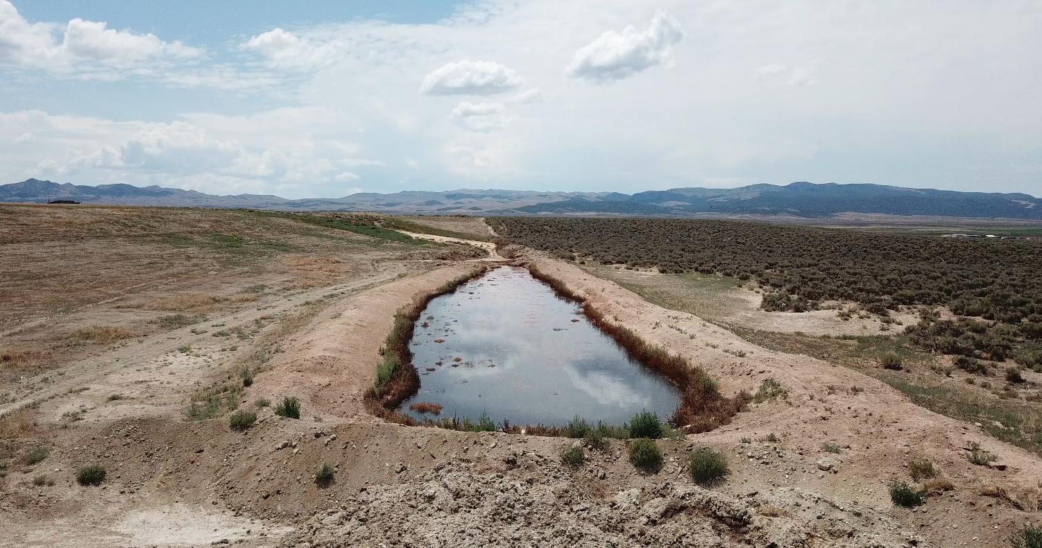 A view from KSL’s drone shows a pond of rotting milk and algal blooms on property in Greenville, Beaver County, in July.