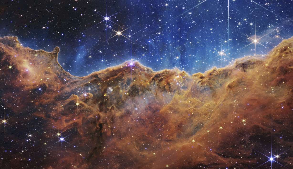 This image released by NASA on July 12 shows the edge of a nearby, young, star-forming region NGC 3324 in the Carina Nebula. Captured in infrared light by the Near-Infrared Camera (NIRCam) on the James Webb Space Telescope, this image reveals previously obscured areas of star birth, according to NASA.
