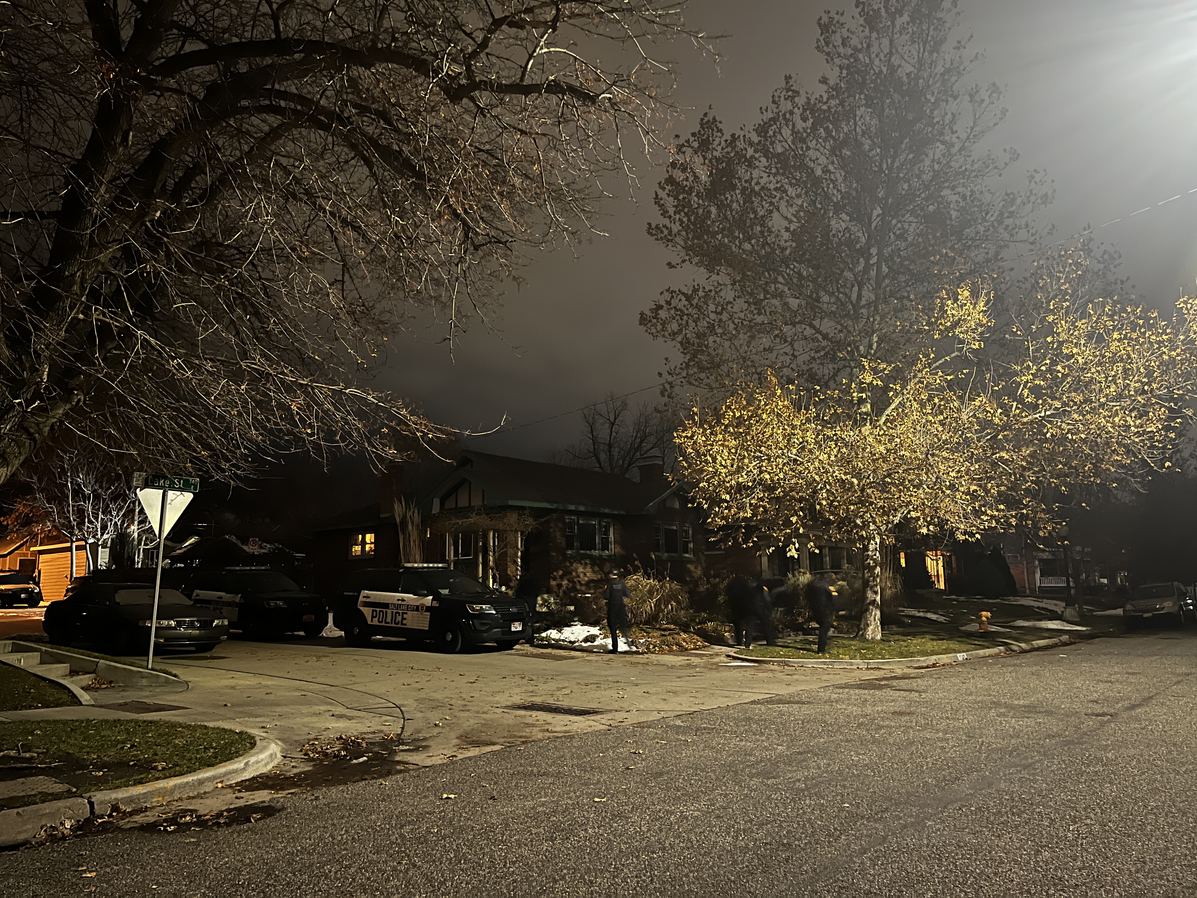 Salt Lake police investigate a shooting on Lake Street on Thursday. A woman remained hospitalized Friday and police say the suspected shooter, her brother, was found dead.