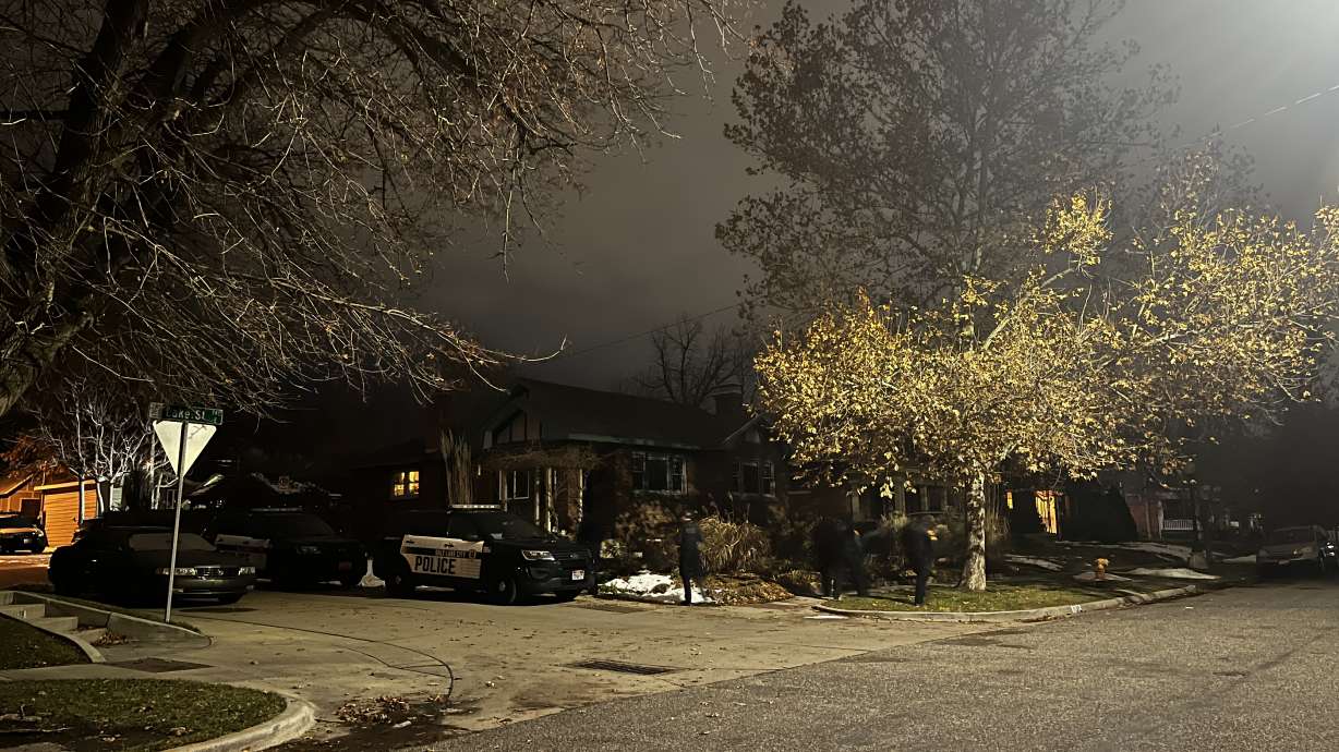 Salt Lake police investigate a shooting on Lake Street on Thursday. A woman remained hospitalized Friday and police say the suspected shooter, her brother, was found dead.