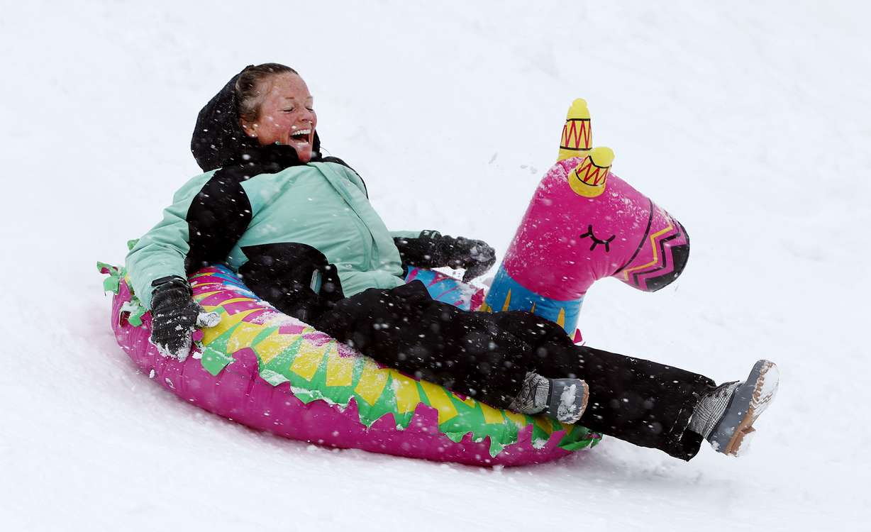 Jennifer Short, of Houston Texas, enjoys the snow as she and members of her family join other sledders in Big Cottonwood Canyon on Friday, Dec. 30.