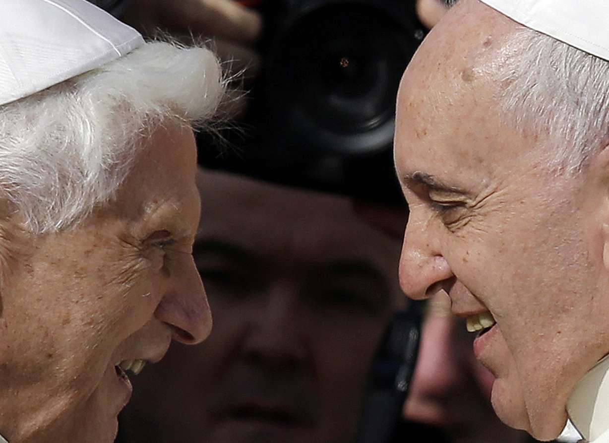 Pope Francis, right, greets Pope Emeritus Benedict XVI prior to the start of a meeting with elderly faithful in St. Peter's Square at the Vatican on Sept. 28, 2014. Pope Emeritus Benedict XVI, the German theologian who will be remembered as the first pope in 600 years to resign, has died, the Vatican announced Saturday. He was 95.