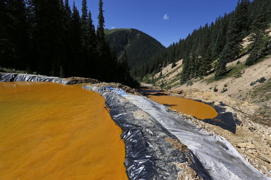 In this Aug. 14, 2015, photo, water flows through a series of sediment retention ponds built to reduce heavy metal and chemical contaminants from the Gold King Mine wastewater accident outside Silverton, Colorado.  officials are disputing a key claim by federal agencies about a massive spill of toxic wastewater from an inactive mine. A report by the federal Bureau of Reclamation, said two state mining experts signed off on an Environmental Protection Agency cleanup project that led to the Aug. 5, 2015, spill at the Gold King Mine in southwest Colorado.

