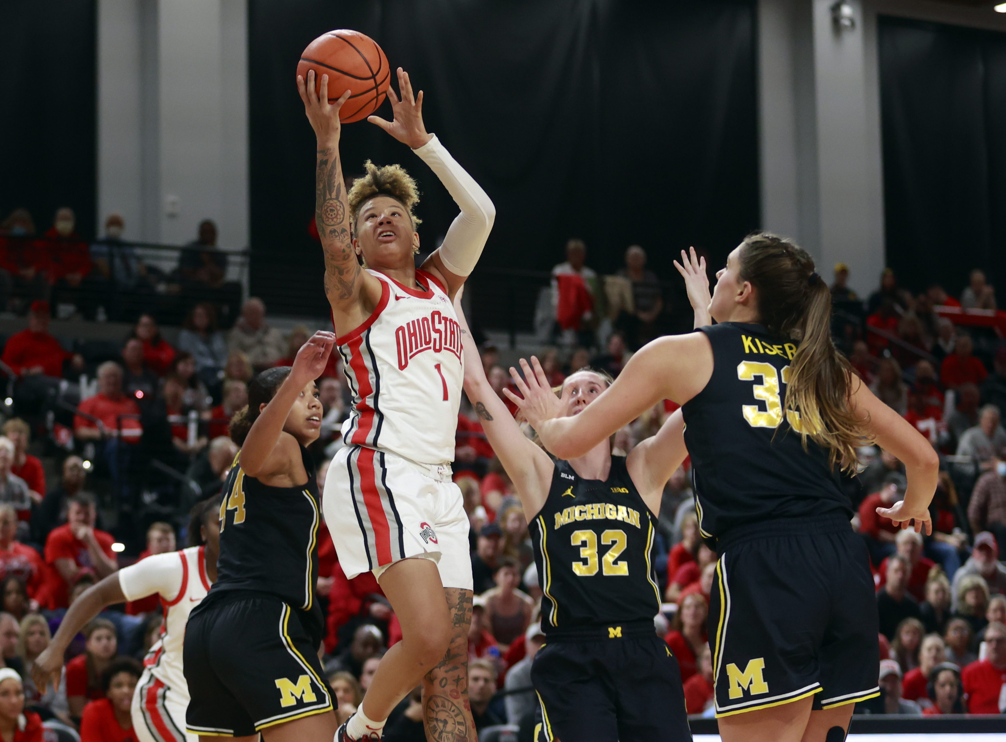 Ohio State guard Rikki Harris (1) shoots between Michigan forward Cameron Williams (44), guard Leigha Brown (32) and forward Emily Kiser (33) during the second half of an NCAA college basketball game in Columbus, Ohio, Saturday, Dec. 31, 2022. Ohio State won 66-57. 