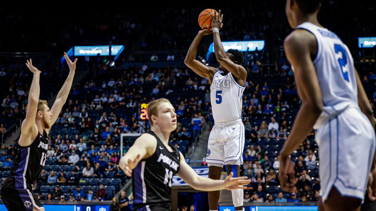 BYU wing Gideon George shoots over the Portland defense during a 71-58 win over the Pilots, Saturday, Dec. 31, 2022 at the Marriott Center in Provo.