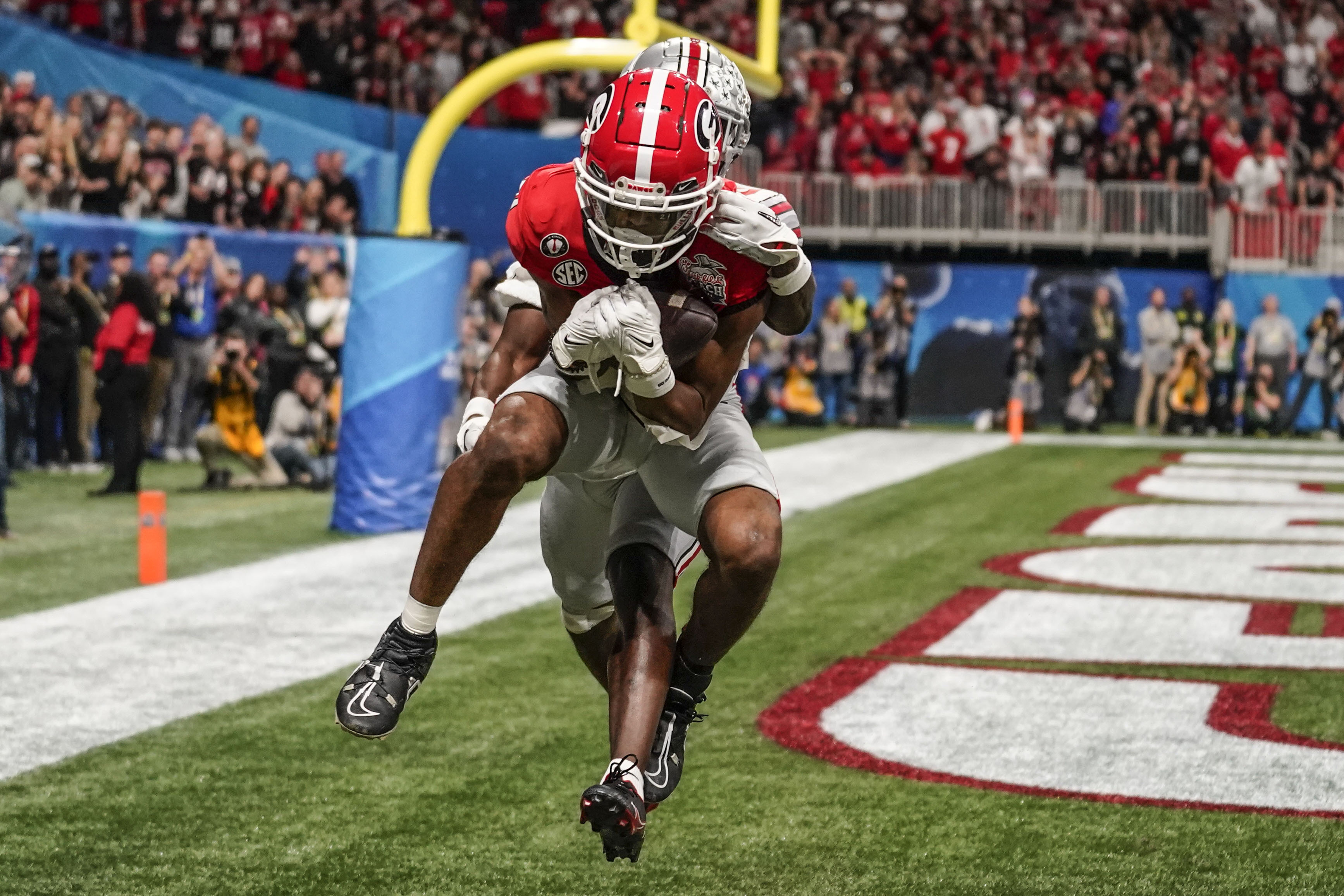 Georgia wide receiver Adonai Mitchell (5) makes a touchdown catch against Ohio State cornerback Denzel Burke (10) during the second half of the Peach Bowl NCAA college football semifinal playoff game, Saturday, Dec. 31, 2022, in Atlanta. 