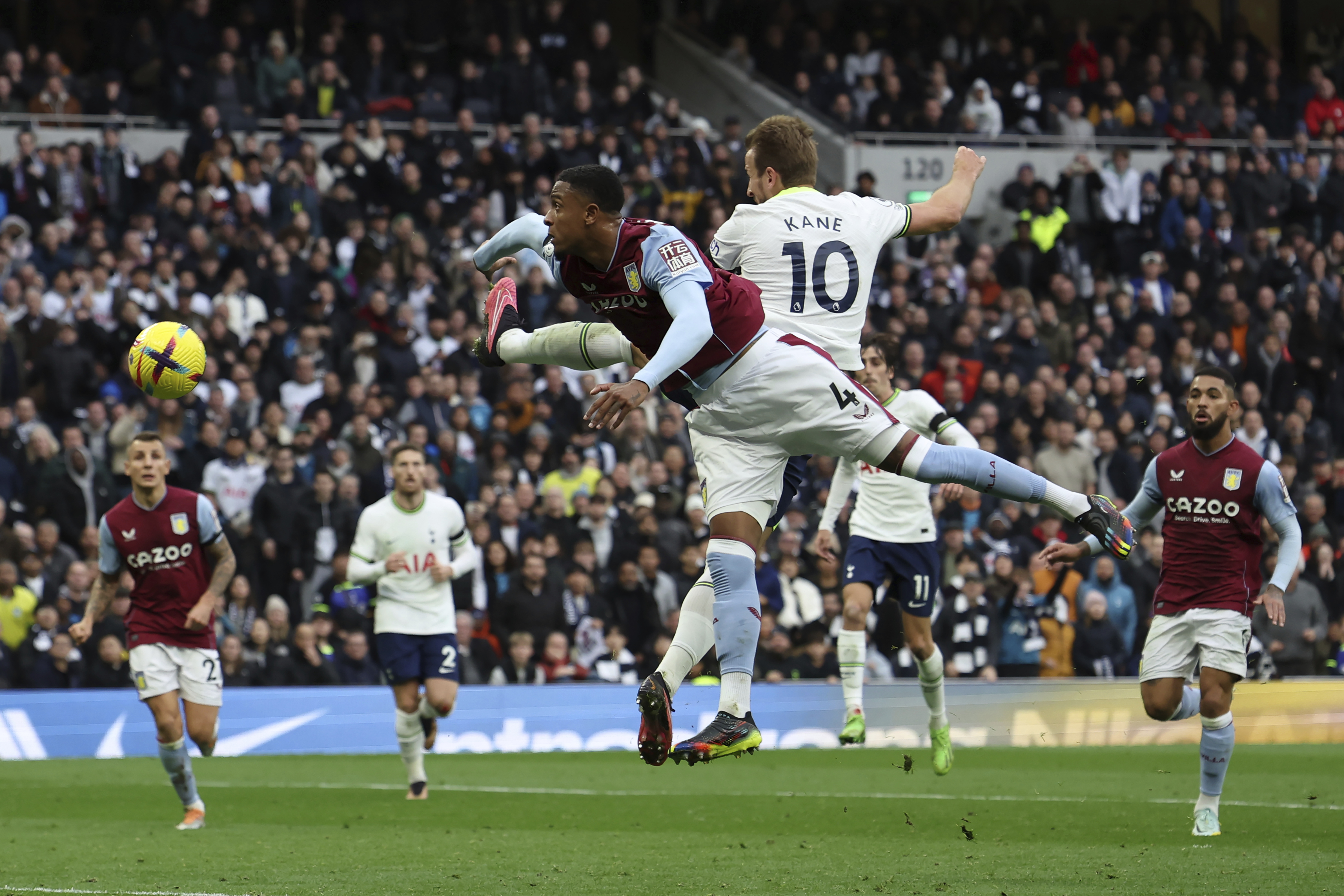 Tottenham's Harry Kane (10) heads past Aston Villa's Ezri Konsa in an attempt to score during the English Premier League soccer match between Tottenham Hotspur and Aston Villa at Tottenham Hotspur Stadium in London, Sunday, Jan. 1, 2023. 