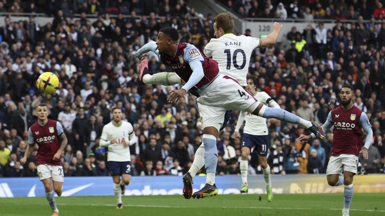 Tottenham's Harry Kane (10) heads past Aston Villa's Ezri Konsa in an attempt to score during the English Premier League soccer match between Tottenham Hotspur and Aston Villa at Tottenham Hotspur Stadium in London, Sunday, Jan. 1, 2023.