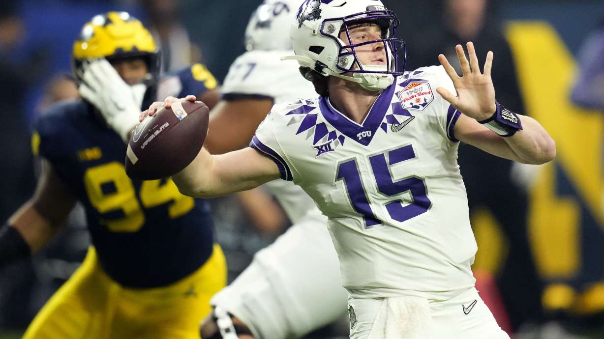 TCU quarterback Max Duggan (15) throws against Michigan during the first half of the Fiesta Bowl NCAA college football semifinal playoff game, Saturday, Dec. 31, 2022, in Glendale, Ariz.