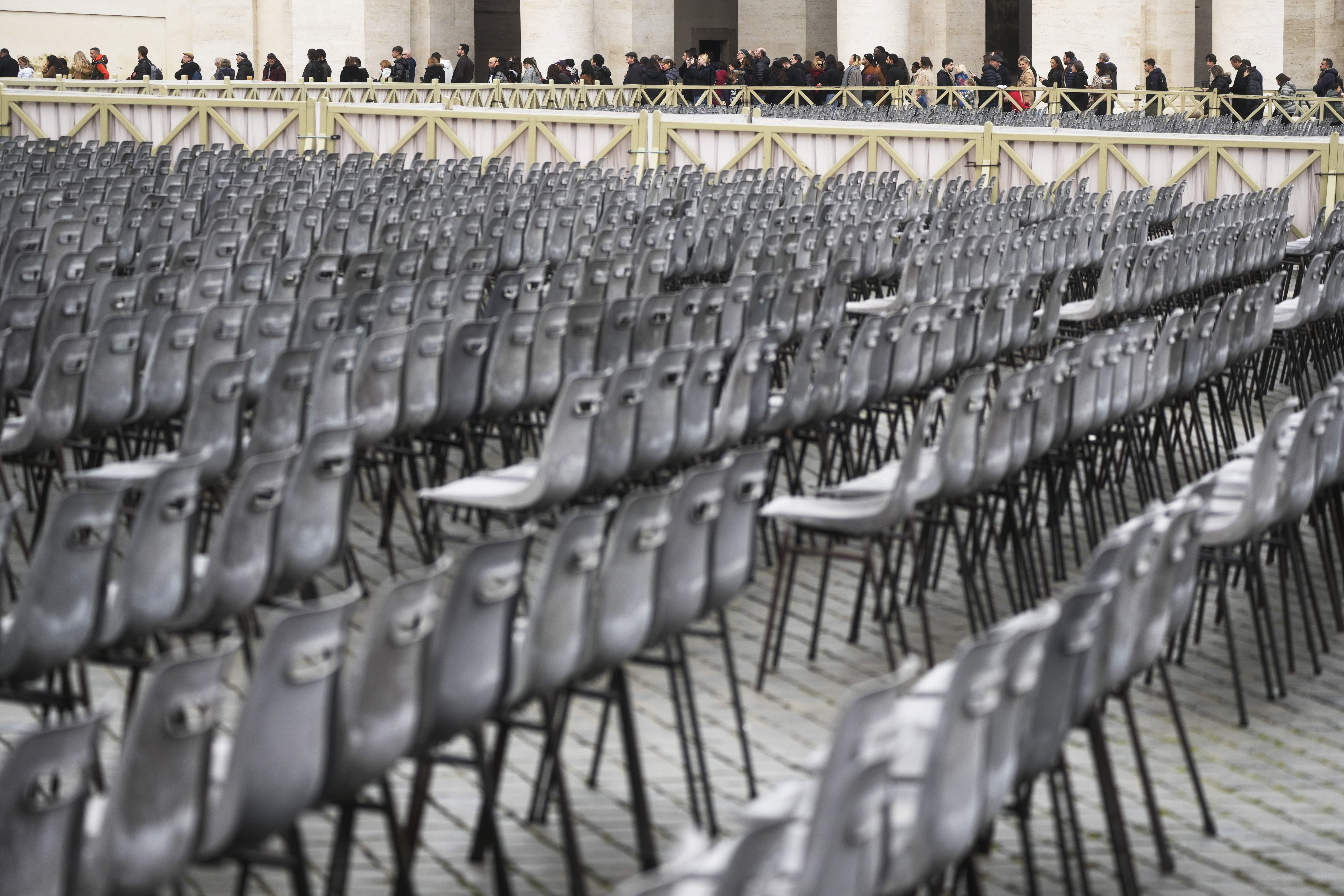 People line up to enter Saint Peter's Basilica at the Vatican where late Pope Benedict XVI is being laid in state at Monday.