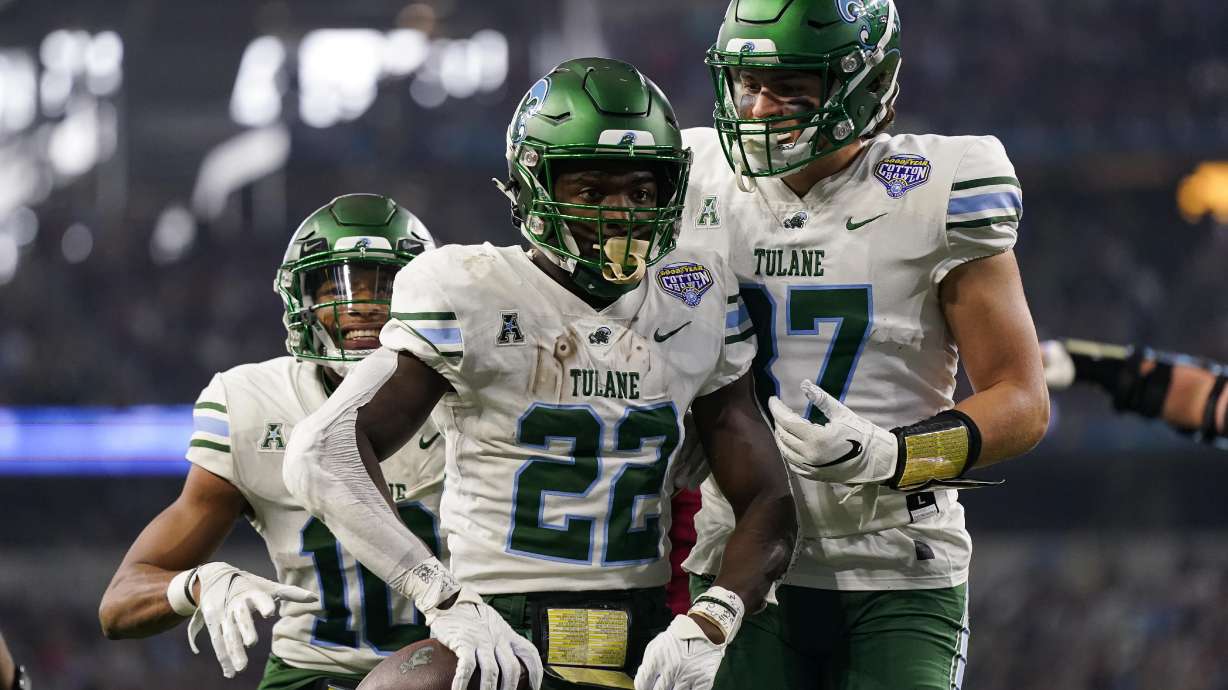 Tulane running back Tyjae Spears (22) celebrates after scoring a touchdown during the first half of the Cotton Bowl NCAA college football game against Southern California, Monday, Jan. 2, 2023, in Arlington, Texas.