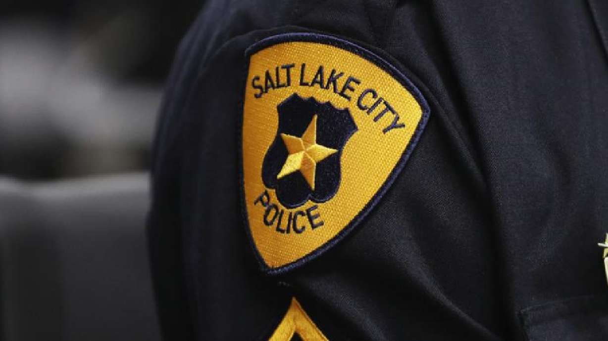 A Salt Lake police officer has been arrested and accused of DUI after allegedly getting into a fight with another driver and pinning the driver's legs with his truck.