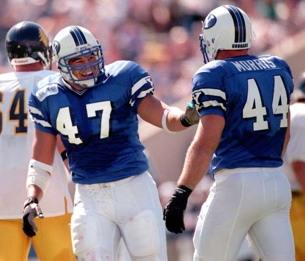 BYU's Justin Ena smiles at Rob Morris after making a tackle against Murray State, Sept. 26, 1998.